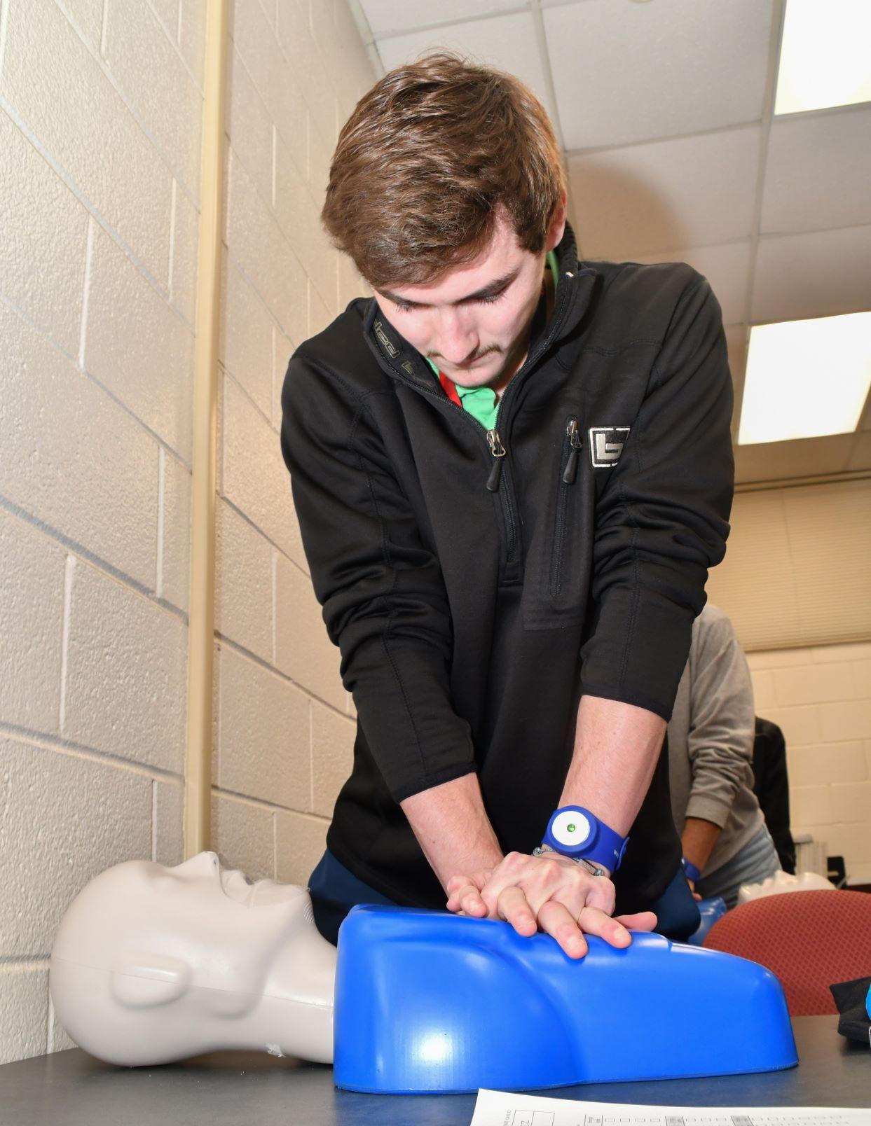 Jared Hodges, a student trainee engineer at Fleet Readiness Center East (FRCE), practices CPR techniques on a training dummy during a class focused on first aid, CPR and use of an automated external defibrillator. While the training is a mandatory requirement for some FRCE employees, the depot’s goal is to enhance readiness by training personnel throughout the work force. 