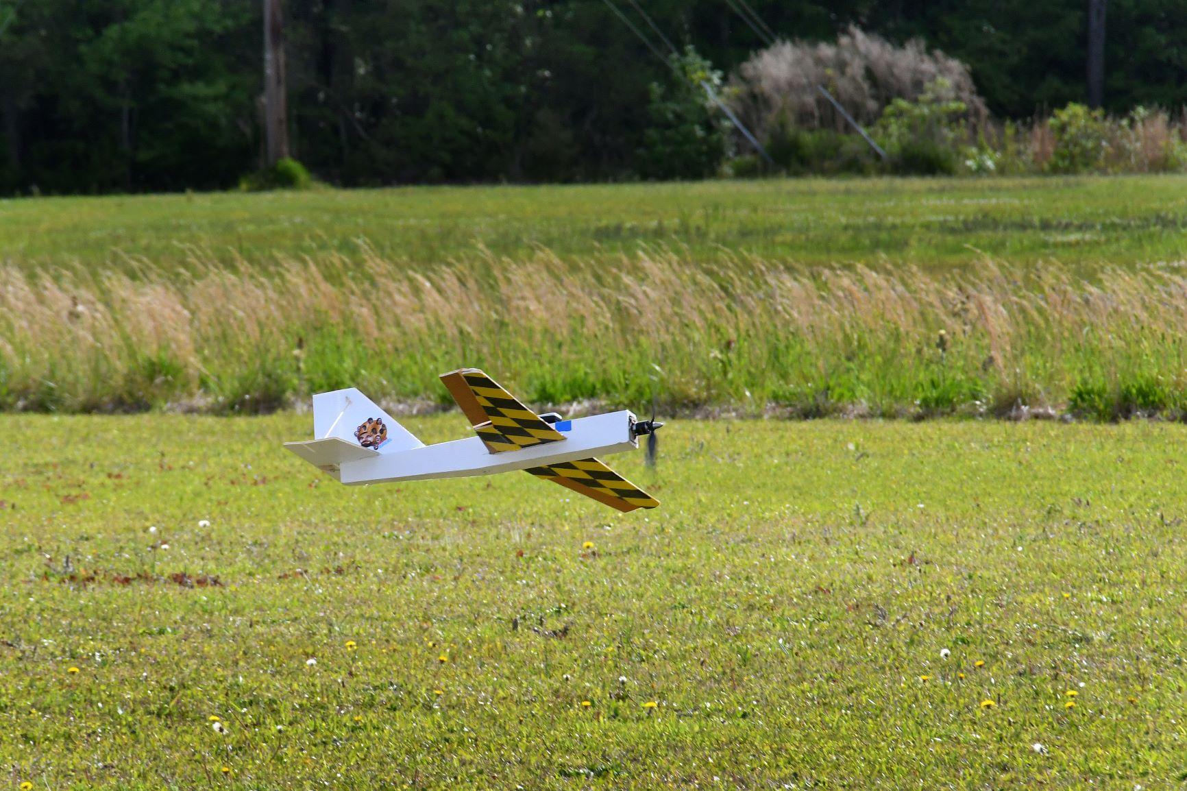 An unmanned aerial vehicle (UAV) heads in for a landing during the 2023 Ultimate Unmanned Aerial Vehicle Competition held April 22, in Newport. Students representing eastern North Carolina high schools designed unmanned aerial vehicles for the competition, which evaluated the speed and maneuverability of their creations. Engineers from Fleet Readiness Center East (FRCE) coached and assisted each team throughout the process.