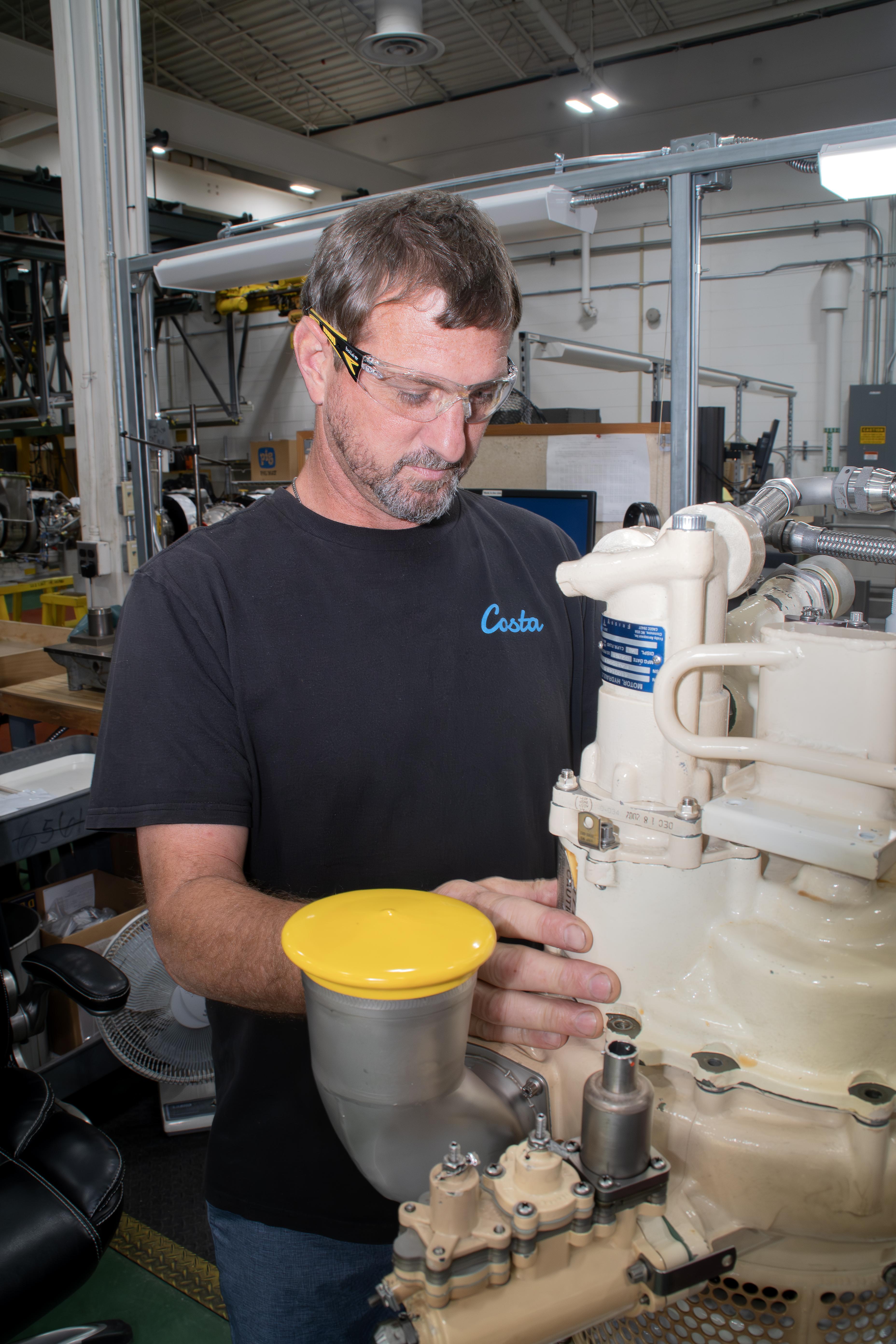 Ryan McNeil, a pneudralics systems mechanic at Fleet Readiness Center East (FRCE) works on an auxiliary power unit used in the F/A-18E/F Super Hornet. FRCE recently achieved a significant production milestone by eliminating high-priority backorders for auxiliary power units used in the Super Hornet, bolstering the platform’s mission readiness.