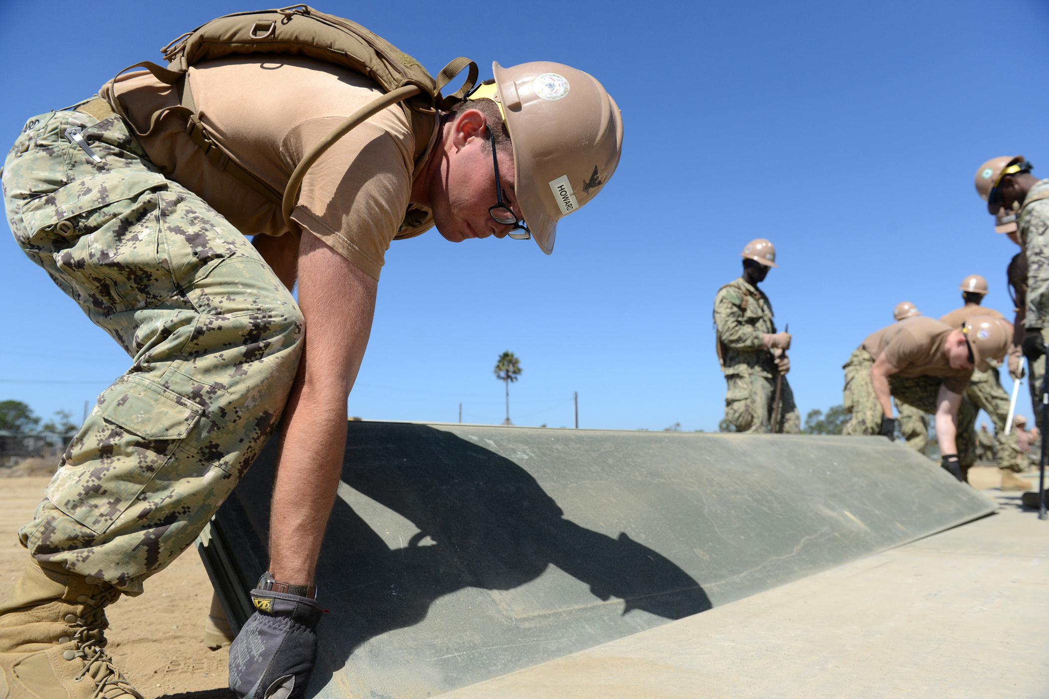 Personnel laying down matting for Expeditionary Airfield