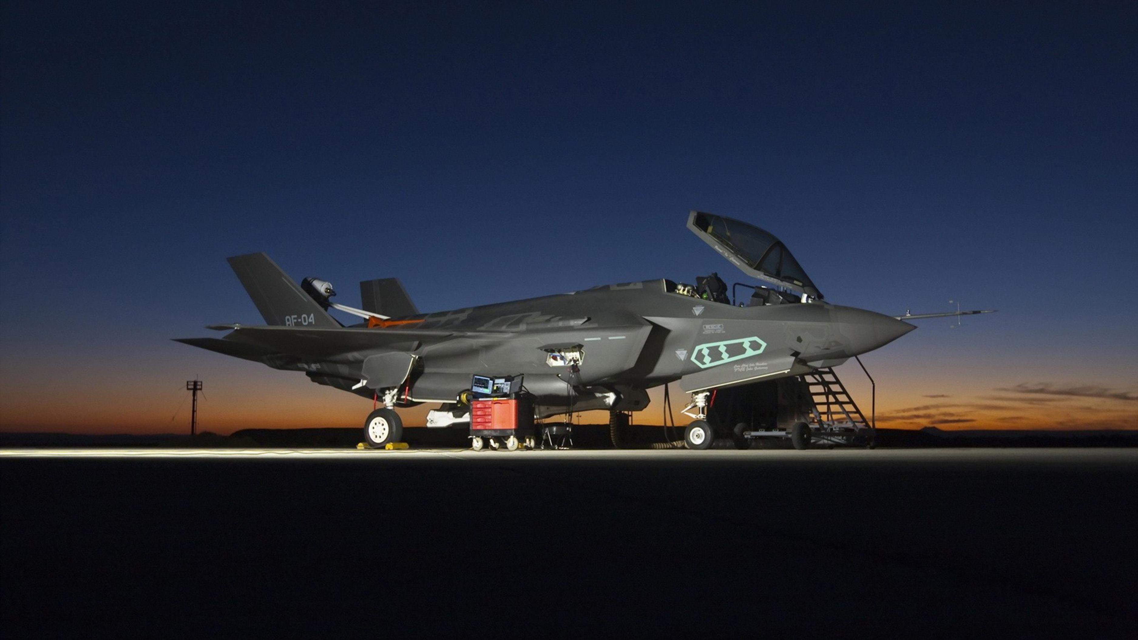 F-35 Joint Strike Fighter aircraft on runway at night