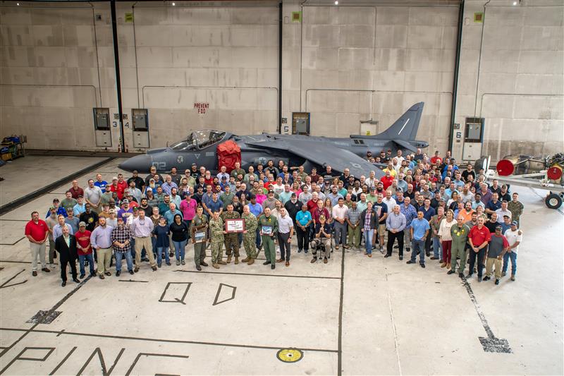 large group of people in front of AV-8B Harrier