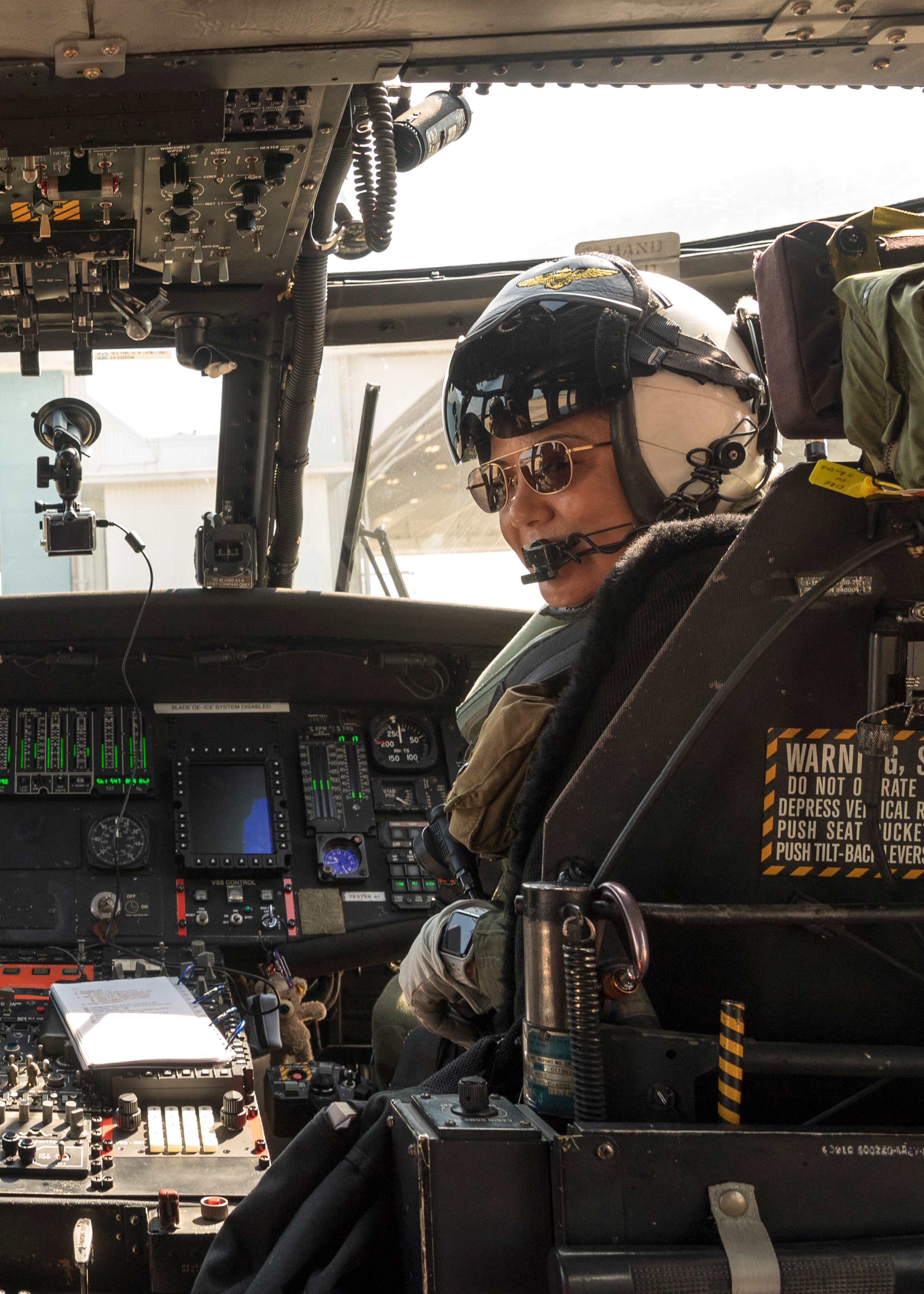 Barb Gordon seated in a UH-60L Black Hawk