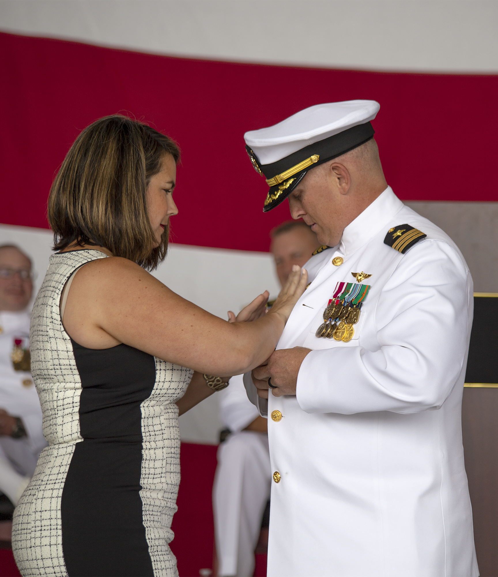 Cmdr. Paul Meyer receives his command pin from his wife