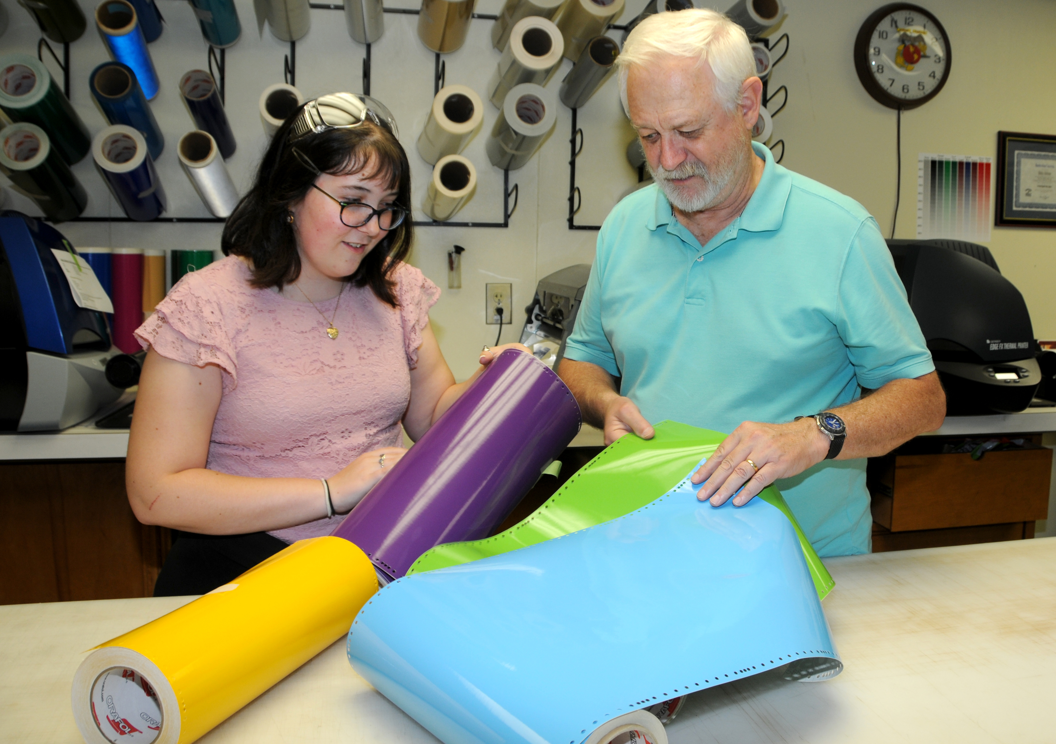 High school student considers color options in adhesive vinyl