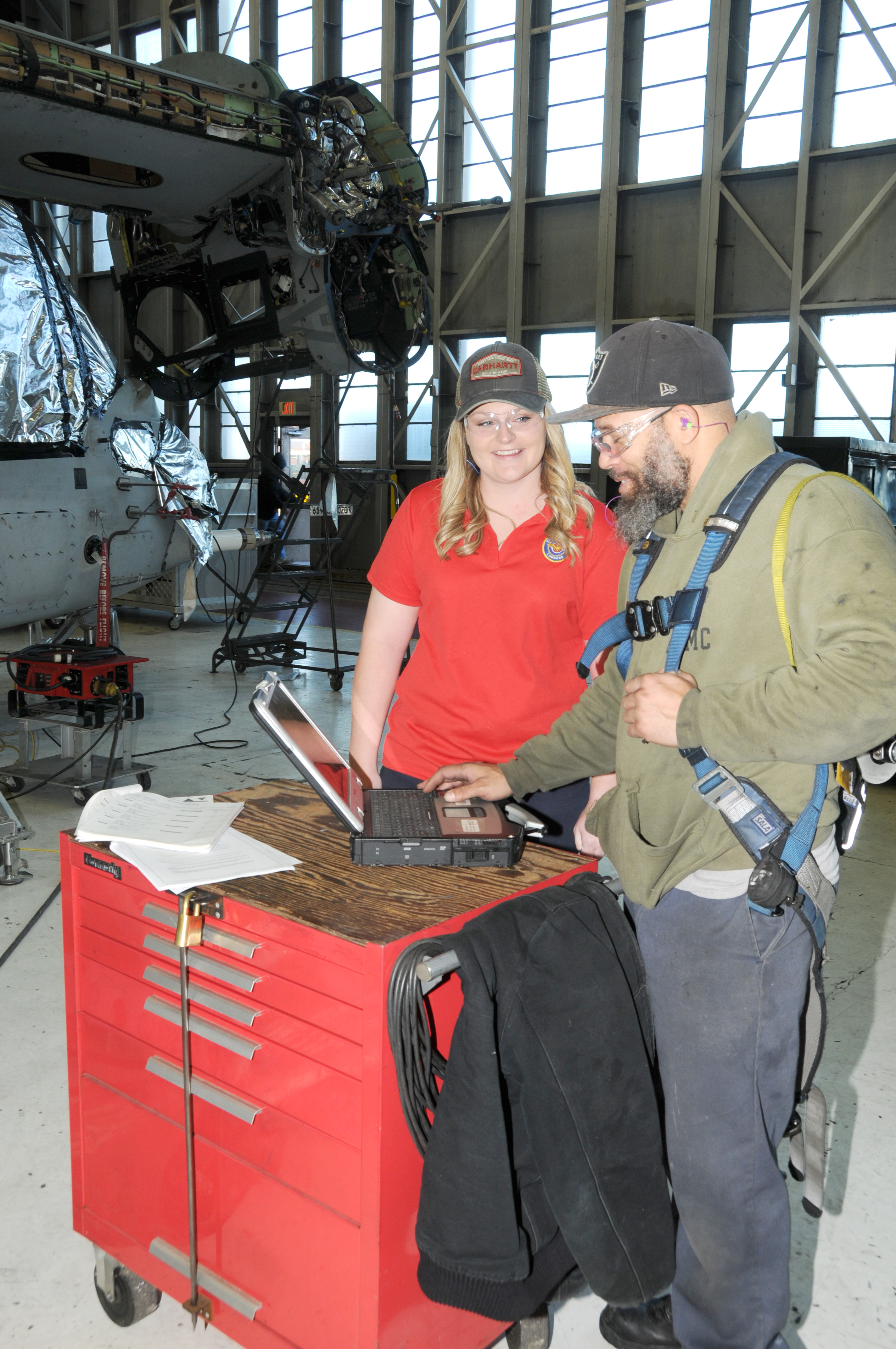 FRCE quality engineer Maddie Dunton works with aircraft mechanic Arkeith Gough