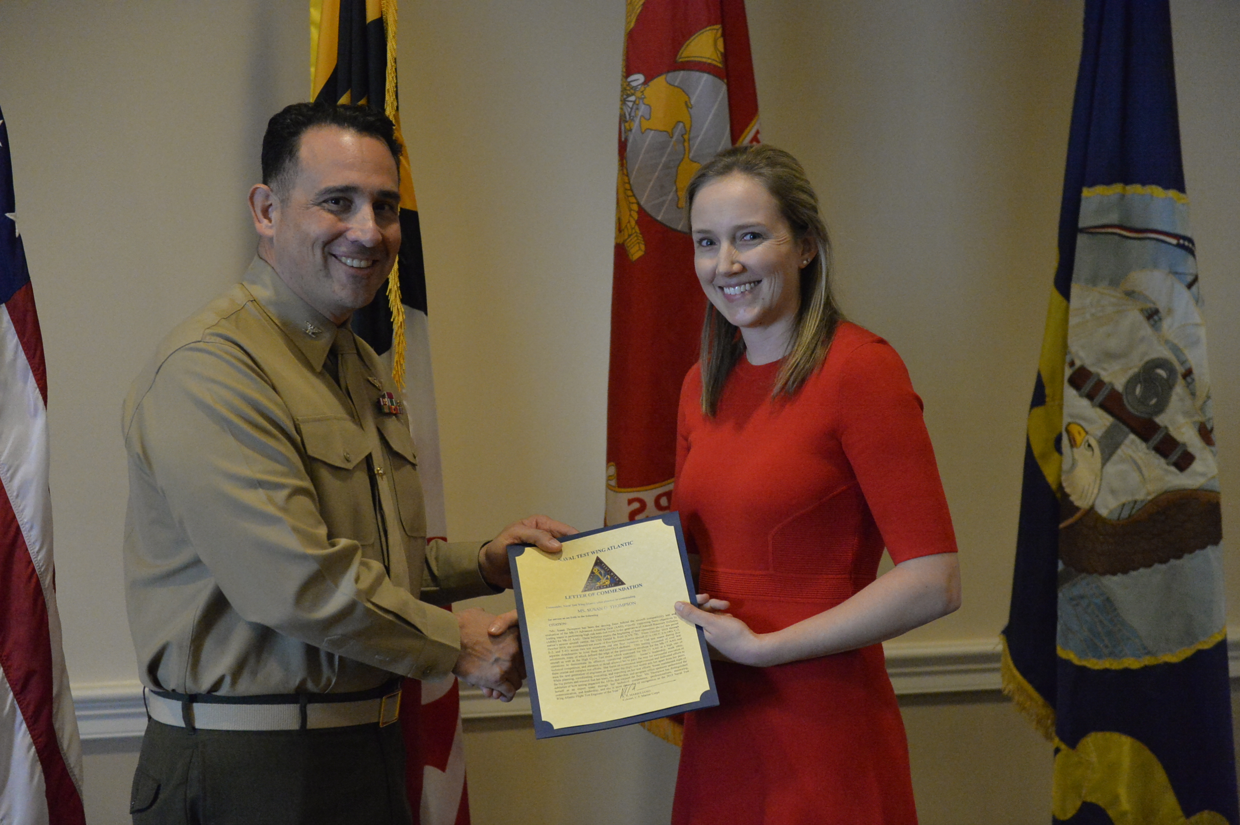 Susan Thompson, right, VX-23’s Flight Test Engineer of the Year for 2019, receives her letter of commendation as Naval Test Wing Atlantic’s Flight Test Engineer of the Year for 2019 from NTWL commander Col. Richard E. Marigliano.