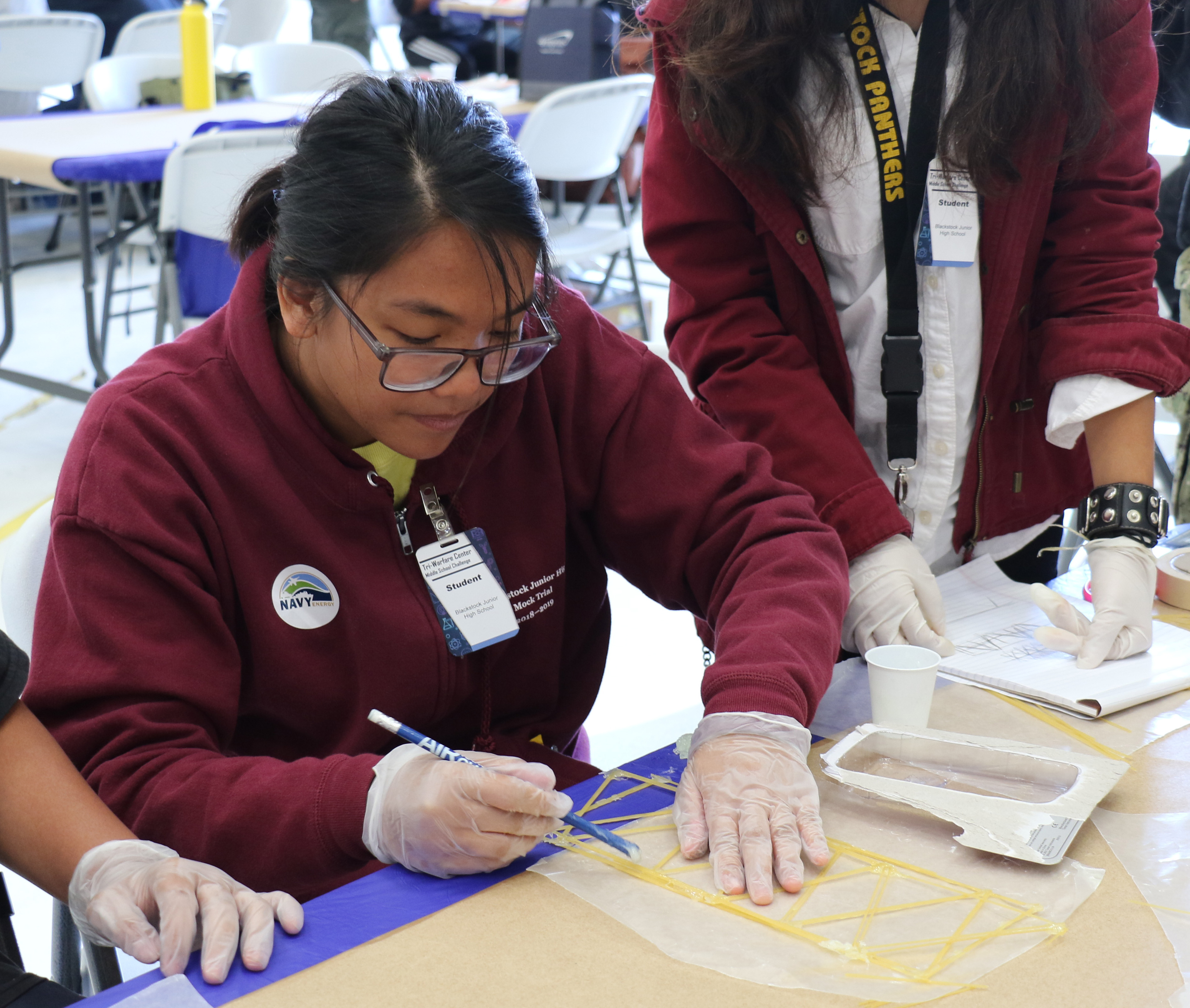 Students from Blackstock Junior High work on their spaghetti bridges during the annual Tri-Warfare Center STEM Challenge in Point Mugu, California, on Feb. 20. (U.S. Navy photo by Kimberly Brown)
