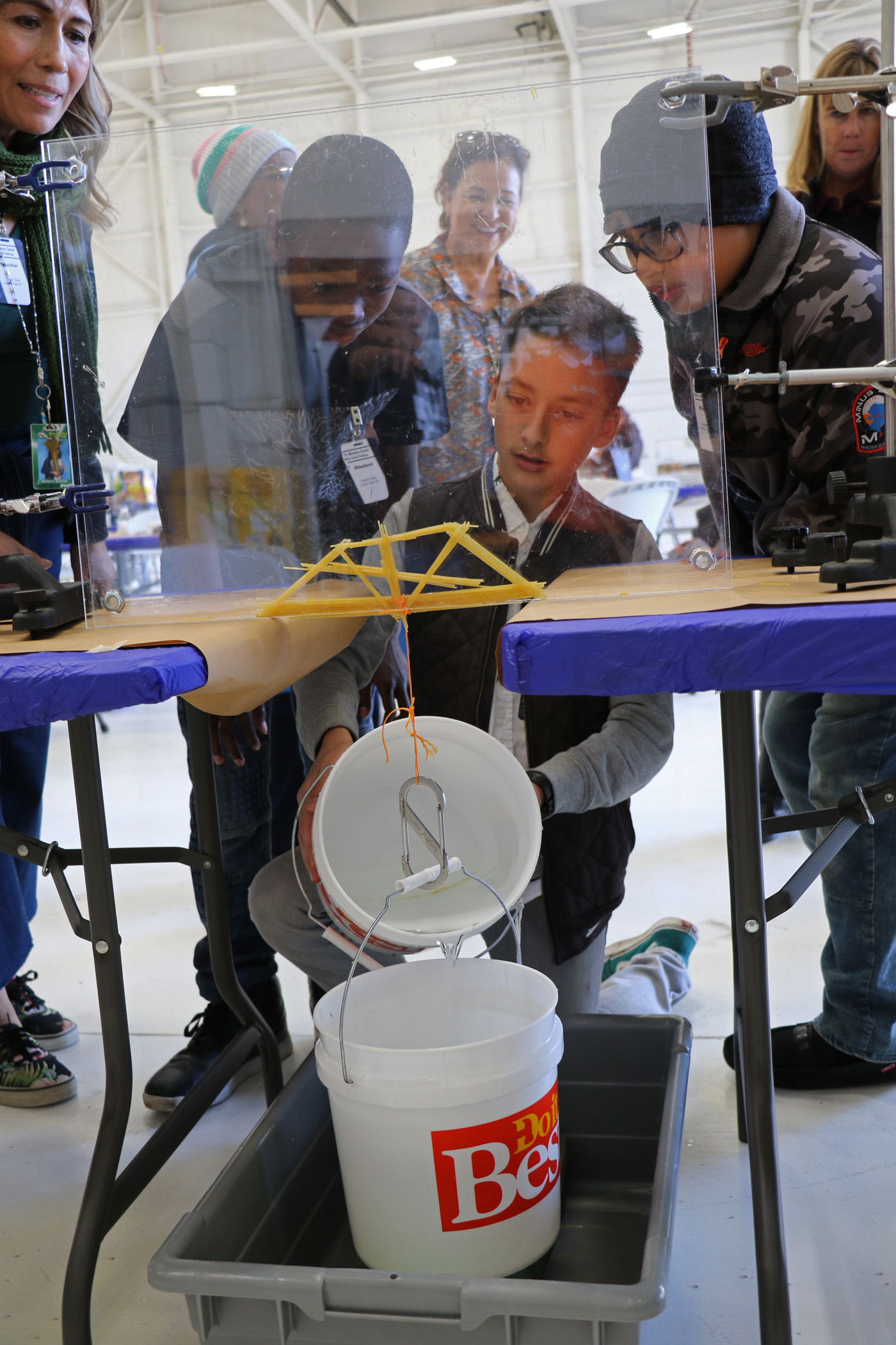 Students test their bridge during the annual Tri-Warfare Center STEM Challenge in Point Mugu, California, on Feb. 20. (U.S. Navy photo by Kimberly Brown)