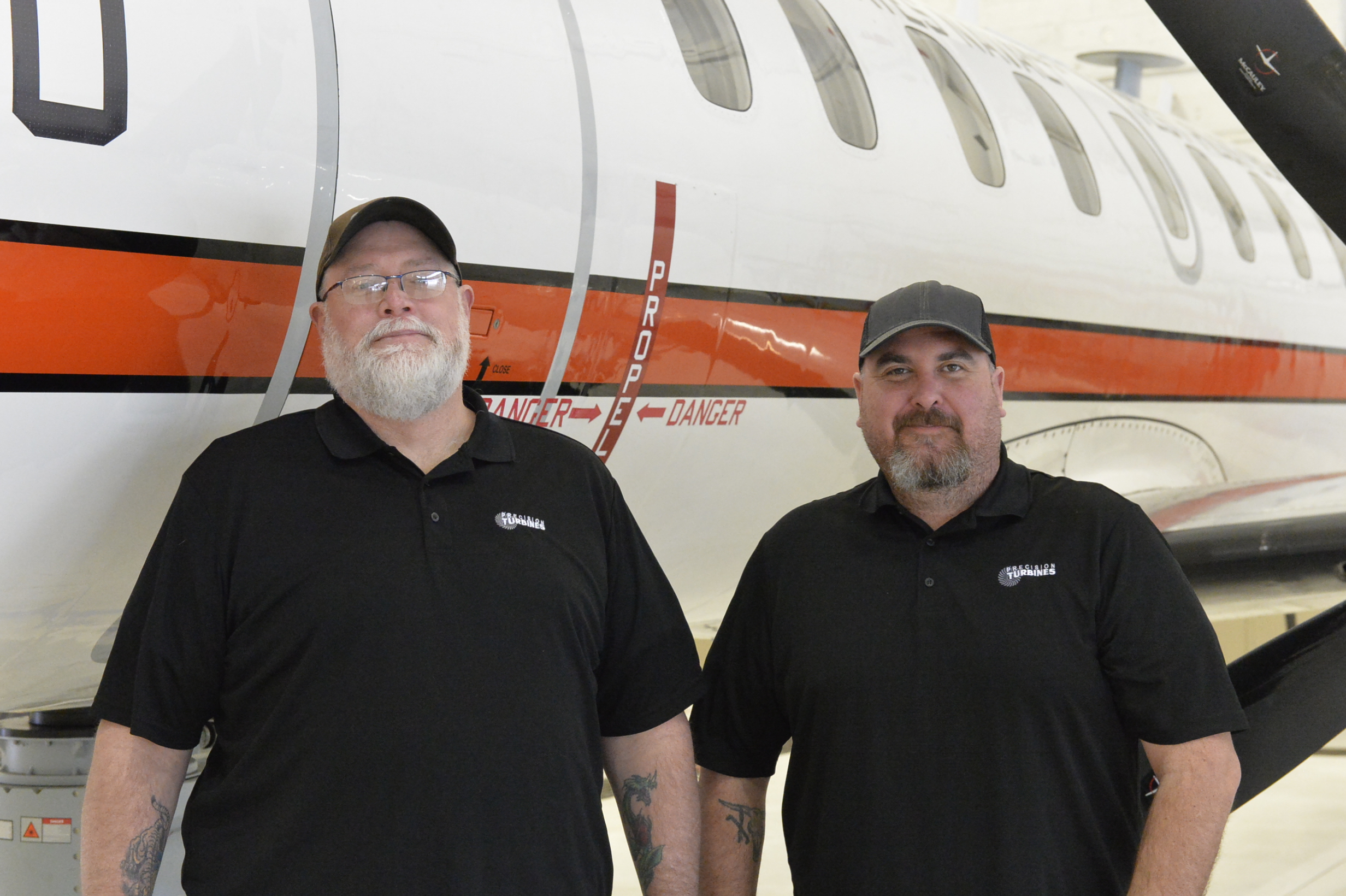 Precision Turbines, Inc., C-26 site manager Dave Wismer, left, and mechanic Zachary Timmons are responsible for maintaining the U.S. Naval Test Pilot School’s ASTARS-III Flying Classroom.