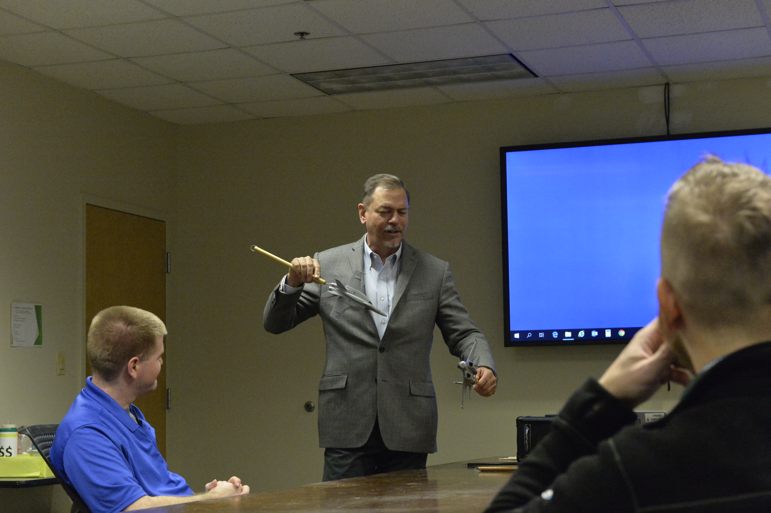 Ian Anderson, director of the Tactical Engineer Development Program at Naval Air Warfare Center Weapons Division, discusses air combat tactics with class participants at Naval Air Station Patuxent River as a way to help them better understand the operational needs of warfighters.