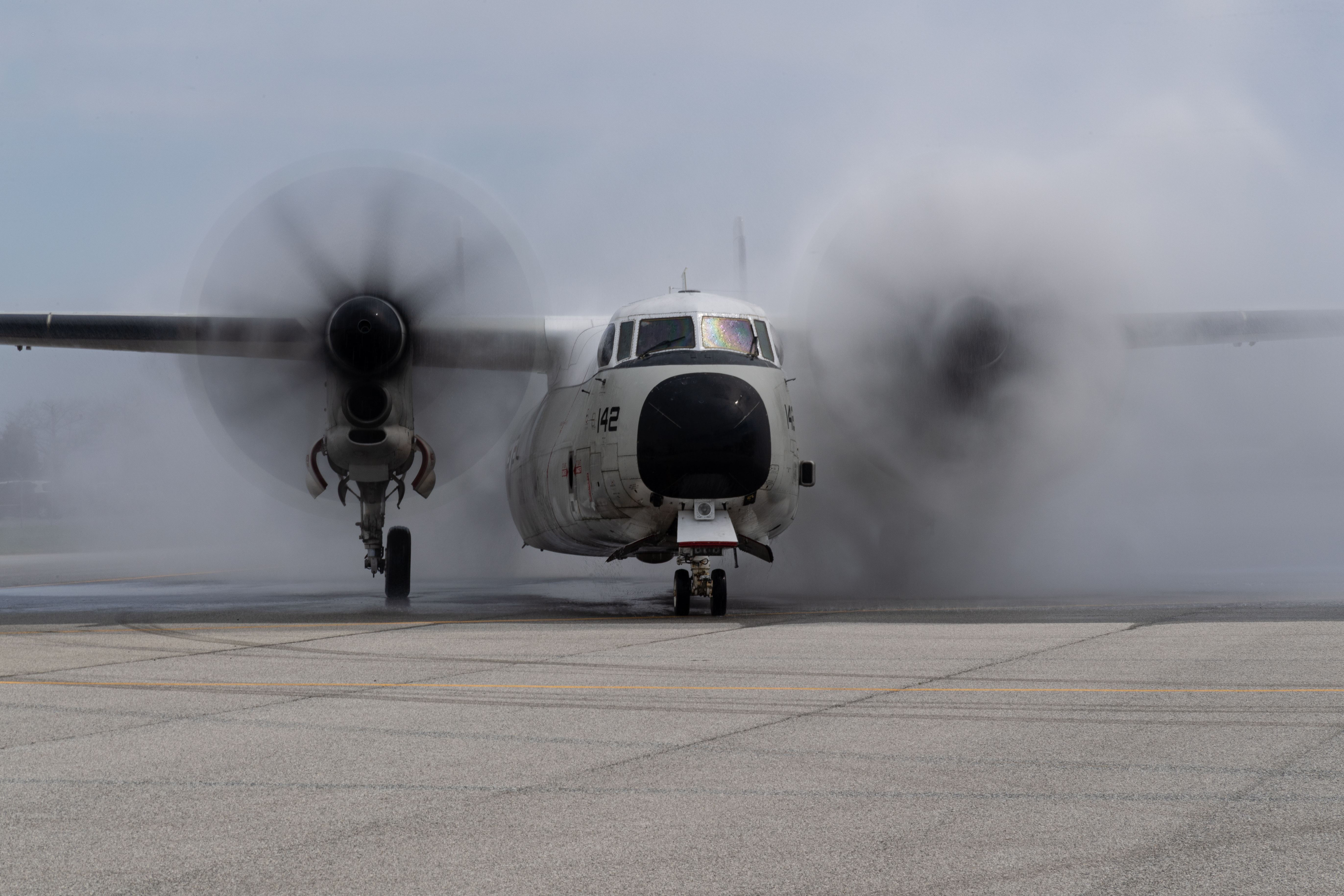 C-2A Greyhound BuNo 162142 rolls through a water cannon salute at Naval Air Station Patuxent River following its final flight on March 19, 2020. (U.S. Navy photo by Steve Wolff)