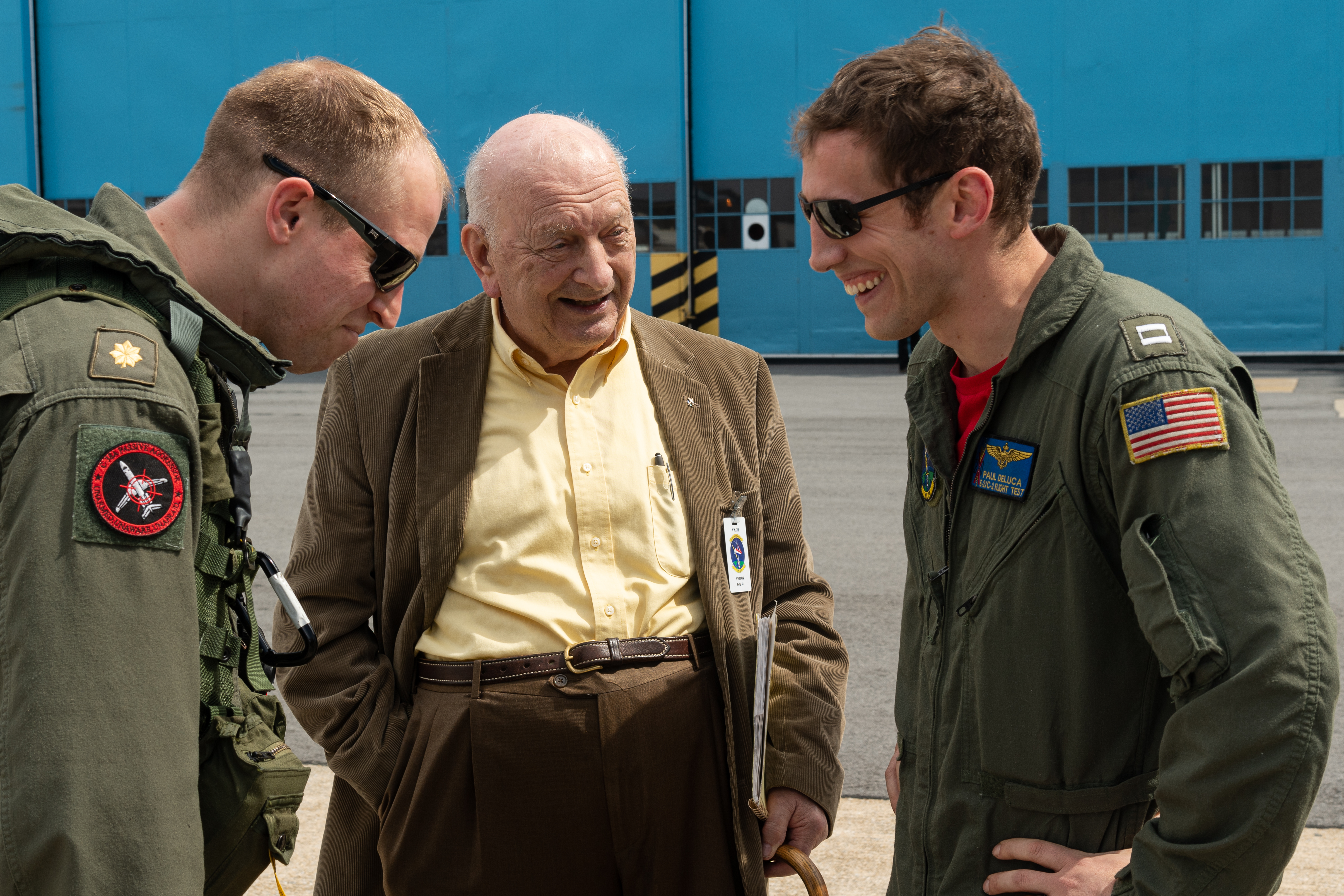 Dave Seeman, center, a retired Grumman test pilot who was one of the first to fly the C-2A Greyhound when it debuted in 1964, shares an anecdote with VX-20 test pilots LCDR Eric “Turbo” Thurber, left, and LT Paul “Digger” Deluca following the final flight of VX-20’s C-2A Greyhound, BuNo 162142 in March. Seeman was the guest of honor for the ceremony welcoming 142 home for the last time. (U.S. Navy photo by Steve Wolff)