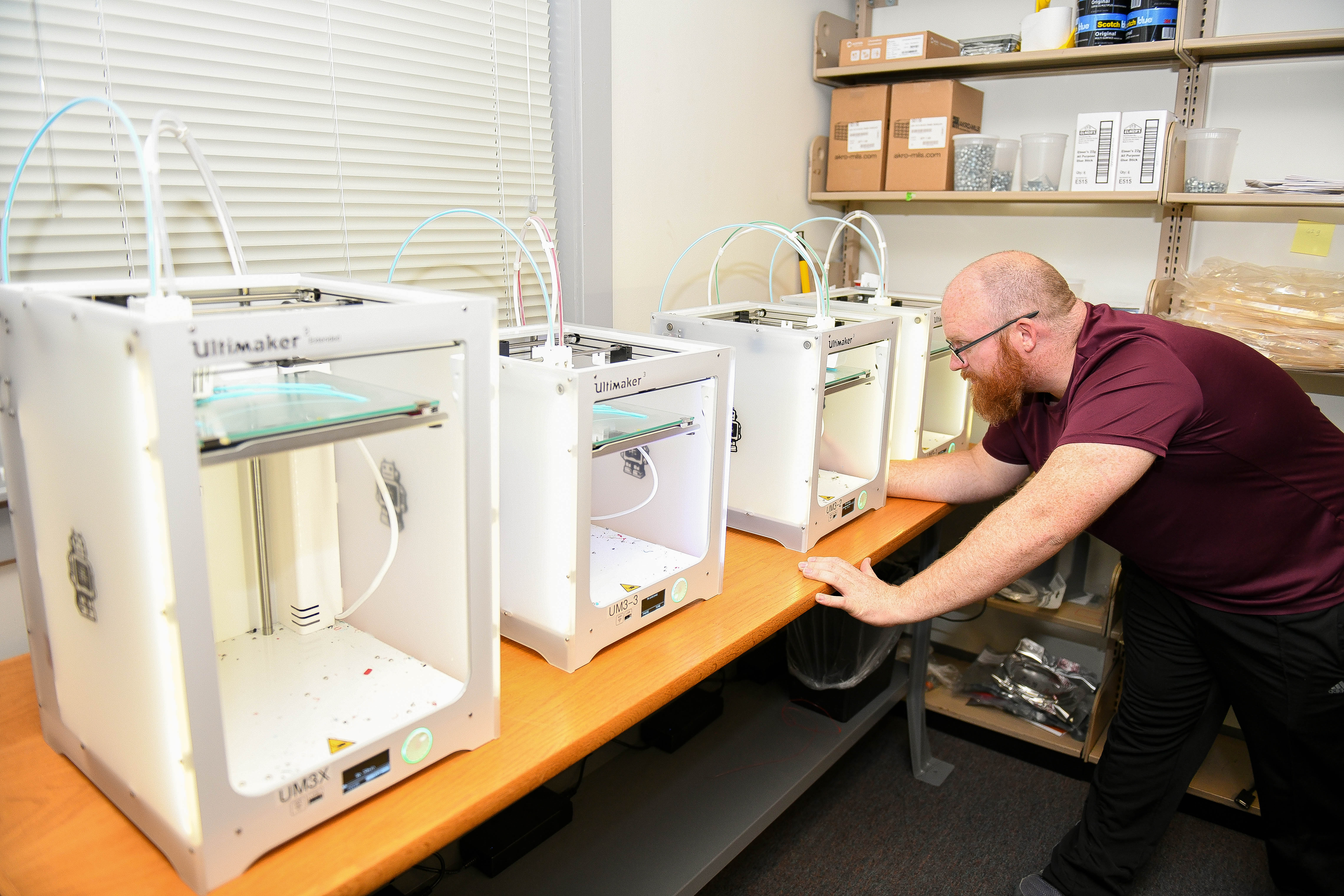 An engineer with NAWCAD facilitates 3D printers producing personal protective equipment in support of the PPE shortage amid COVID-19.