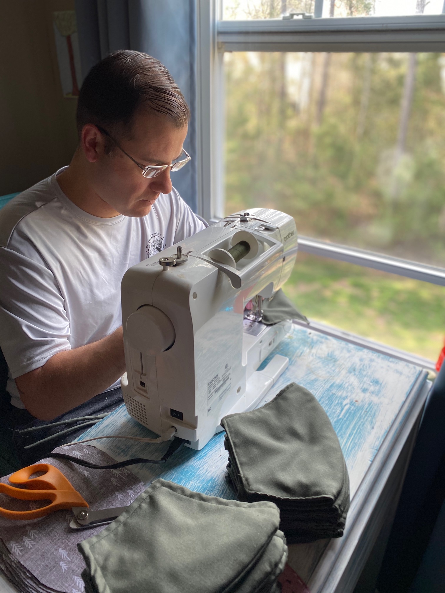 Assistant Maintenance Officer/Material Control Officer Orlando Suazo of Air Test and Evaluation Squadron (HX) 21 works the sewing machine making face masks for medical personnel, first responders, and squadron colleagues. (U.S. Navy photo by Chief Warrant Officer 2 Orlando Suazo)