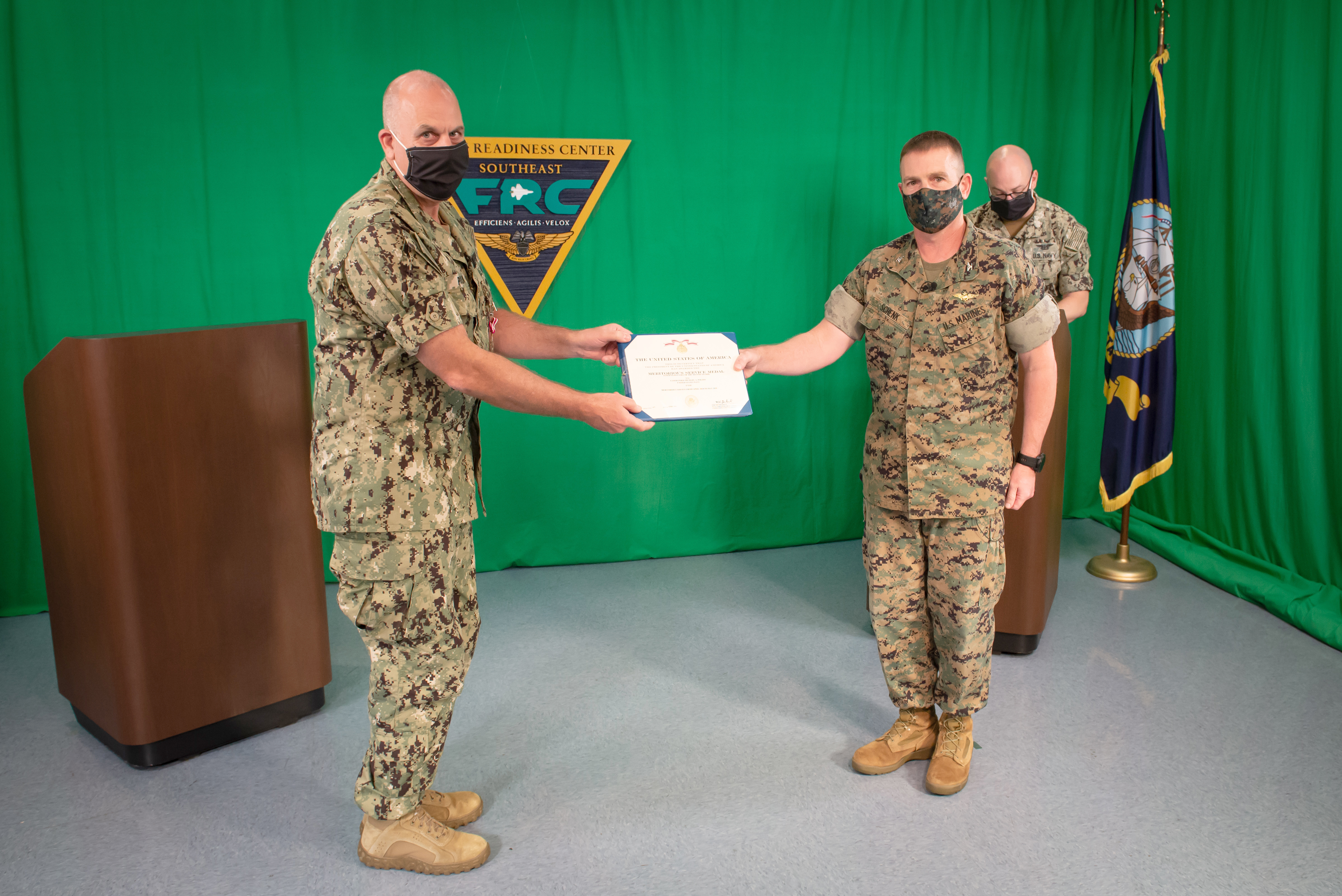 JACKSONVILLE, Fla. (May 21, 2020) Fleet Readiness Center Southeast’s (FRCSE) Commanding Officer, Col. Fred Schenk (right) presents Cmdr. Michael Polito, Officer in Charge (OIC), FRCSE Det. Jacksonville (left), with a Meritorious Service Medal during a Change of Charge ceremony. 