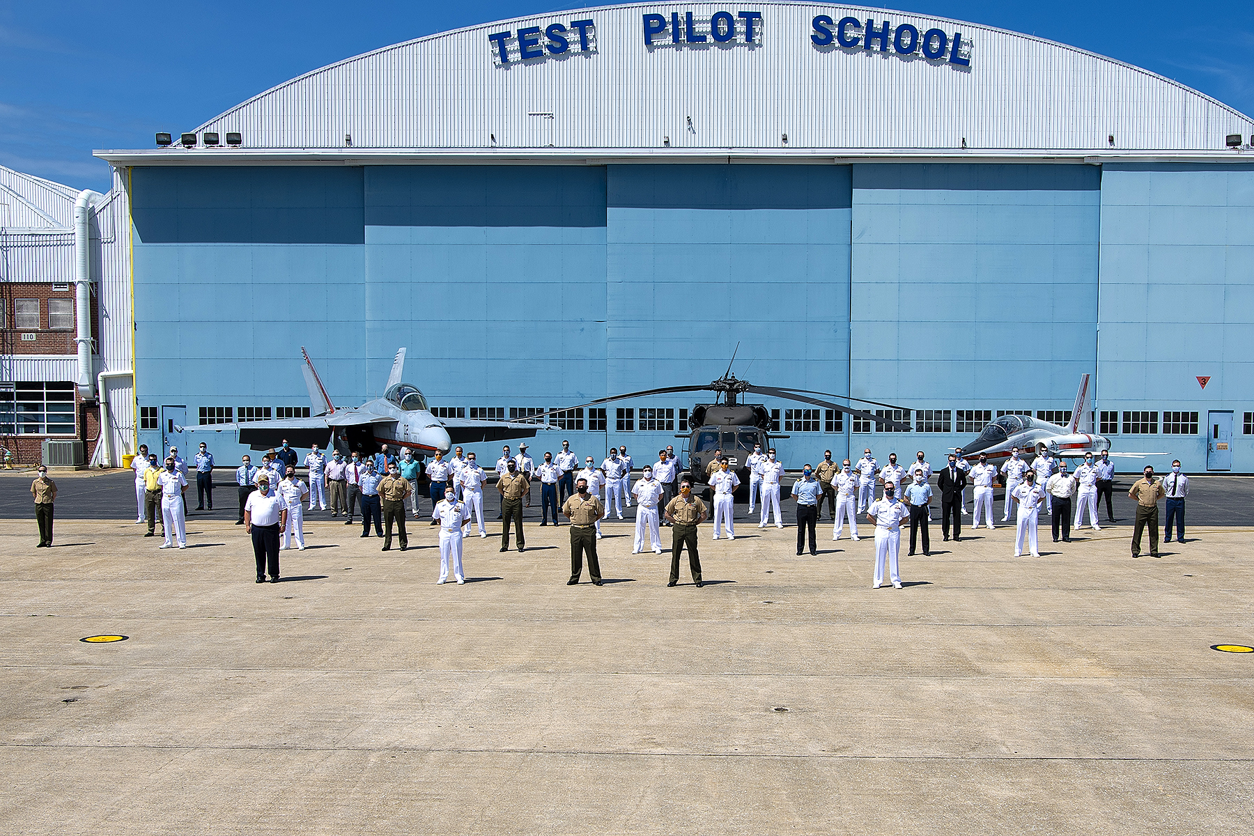 Rear Adm. John S. Lemmon, Commander of the Naval Air Warfare Center Aircraft Division and Assistant Commander for Research and Engineering at Naval Air Systems Command, and Col. Richard Marigliano, Commander of Naval Test Wing Atlantic, pose with the 34 graduates of U.S. Naval Test Pilot School Class 157 and the school’s command staff on Friday prior to the class’ graduation June 5, 2020 at NAS Patuxent River. (U.S. Navy photo)