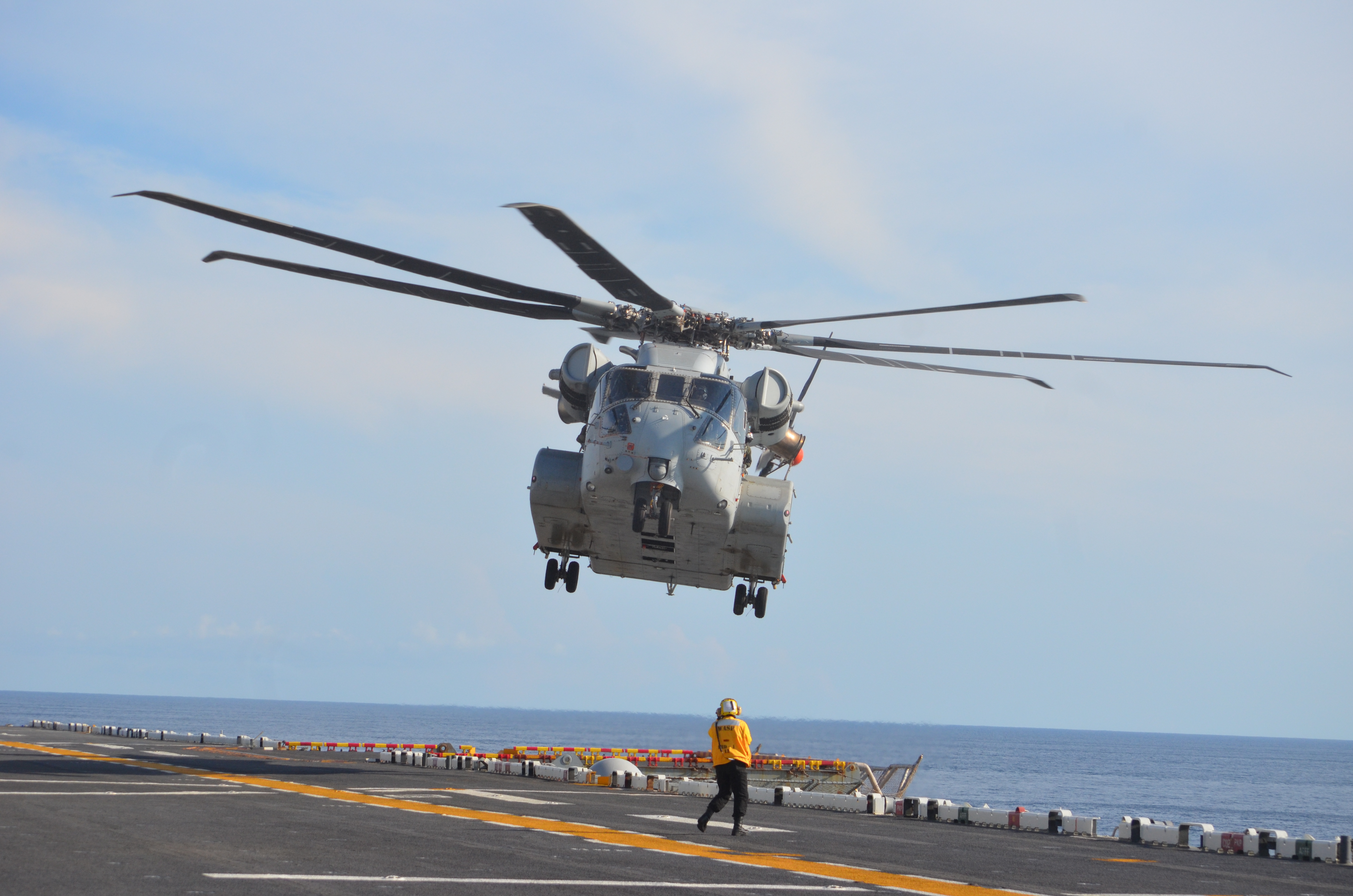 A CH-53K King Stallion belonging to Air Test and Evaluation Squadron (HX) 21 prepares to land aboard the USS Wasp (LHD 1) during sea trials to establish the helicopter's performance envelope for day and night launches and recoveries at a wide range of wind speeds. (U.S. Navy photo)