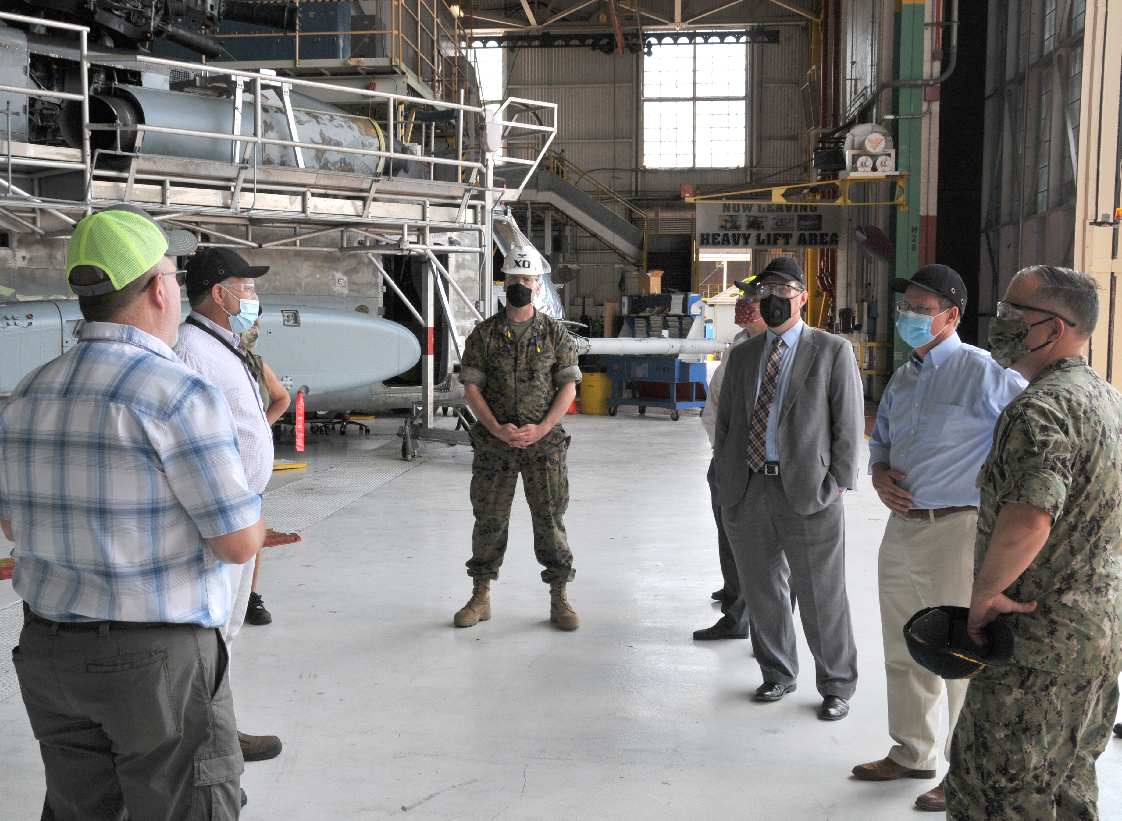 Group stands in front of H-53 helicopter