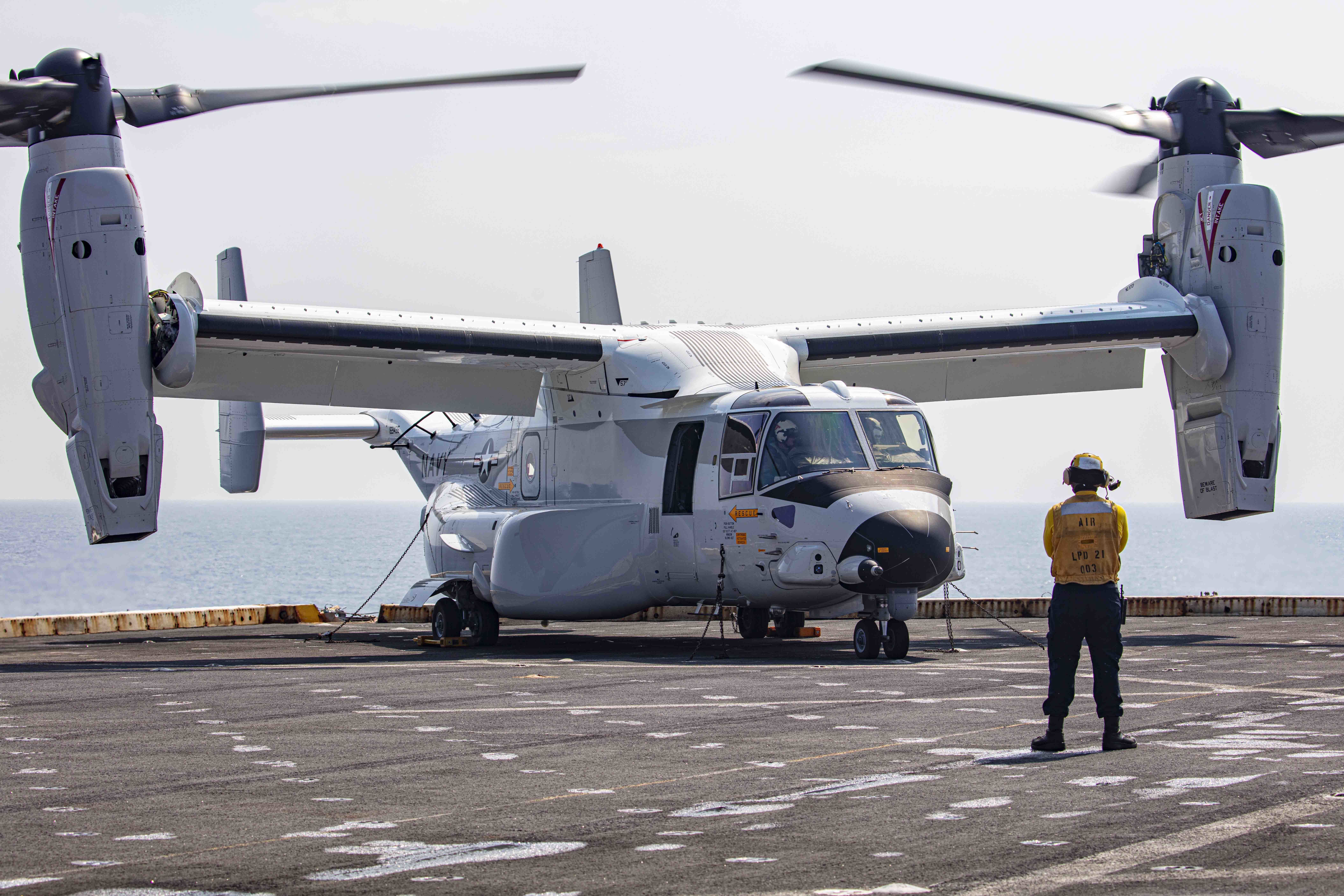 Aviation Boatswain’s Mate (Handling) 3rd Class Lorenzo Moreno, assigned to the transport dock ship USS New York (LPD 21), signals to a CMV-22B Osprey attached to the Blackjacks of Air Test and Evaluation Squadron (HX) 21 on the New York's flight deck on July 18, 2020. (U.S. Navy photo by Mass Communication Specialist 2nd Class Lyle Wilkie/Released)