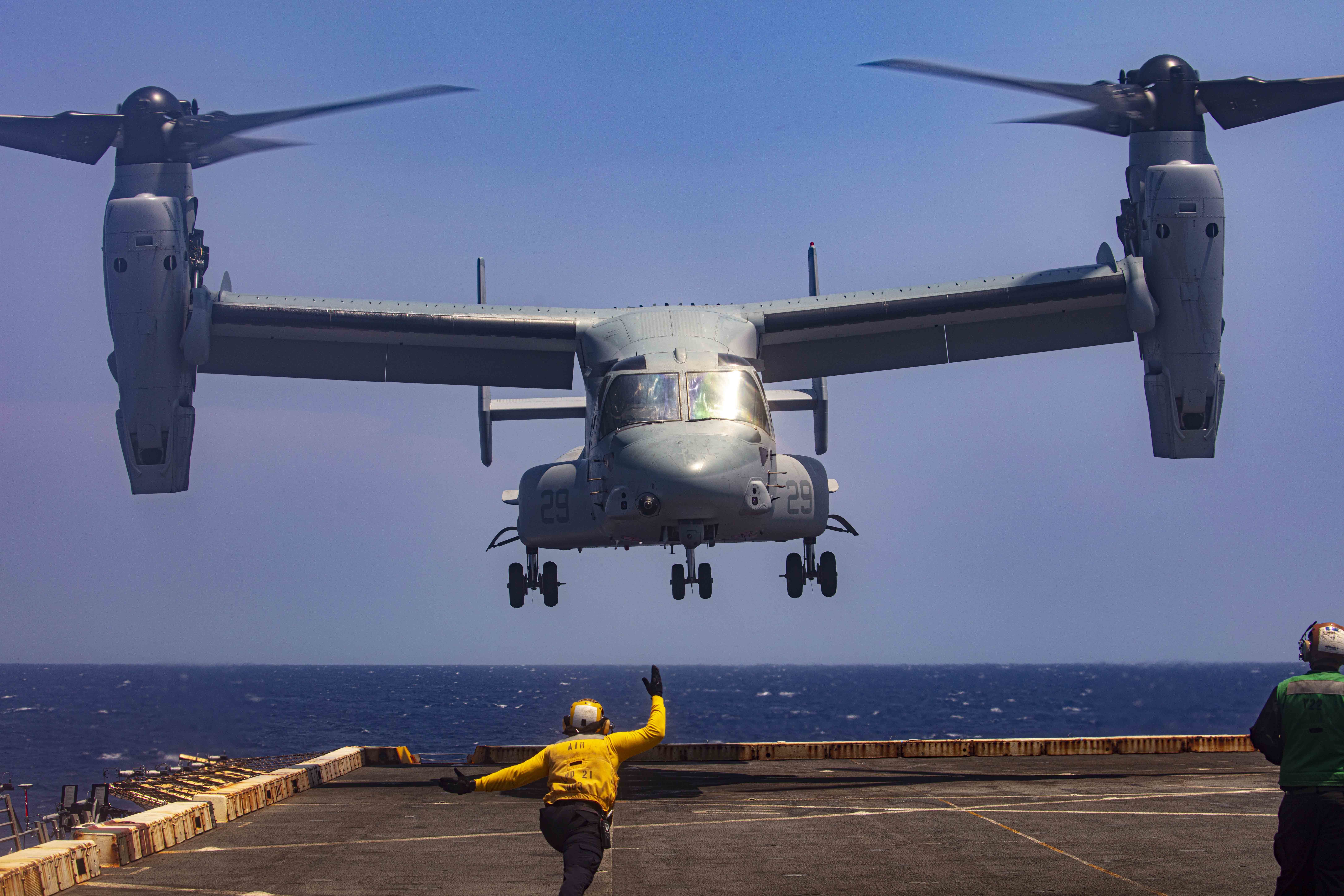 Boatswain’s Mate (Handling) 3rd Class Lorenzo Moreno, assigned to the amphibious transport dock ship USS New York (LPD 21), signals to an MV-22 Osprey attached to the Blackjacks of Air Test and Evaluation Squadron (HX) 21 on July 20, 2020. (U.S. Navy photo by Mass Communication Specialist 2nd Class Lyle Wilkie/Released)