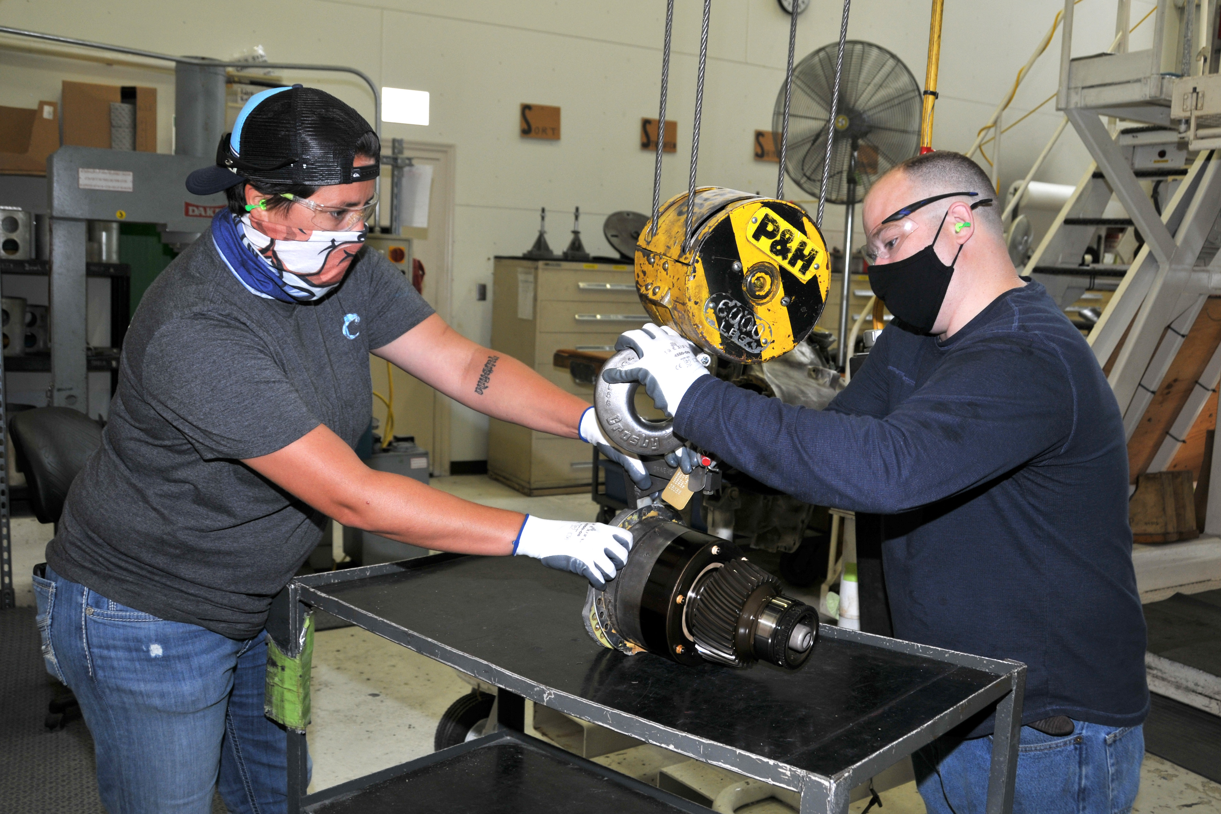FRCE artisans use crane to lift H-53 nose gearbox assembly.