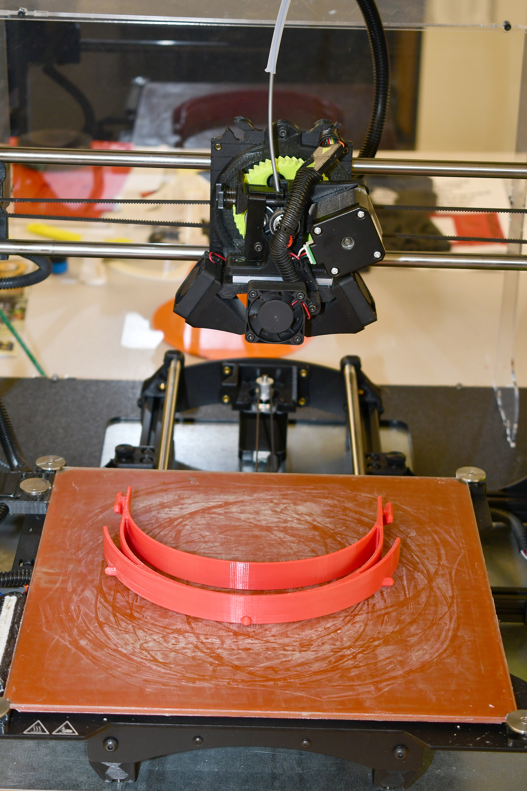 A 3D printer lays down layers of plastic to manufacture a headband