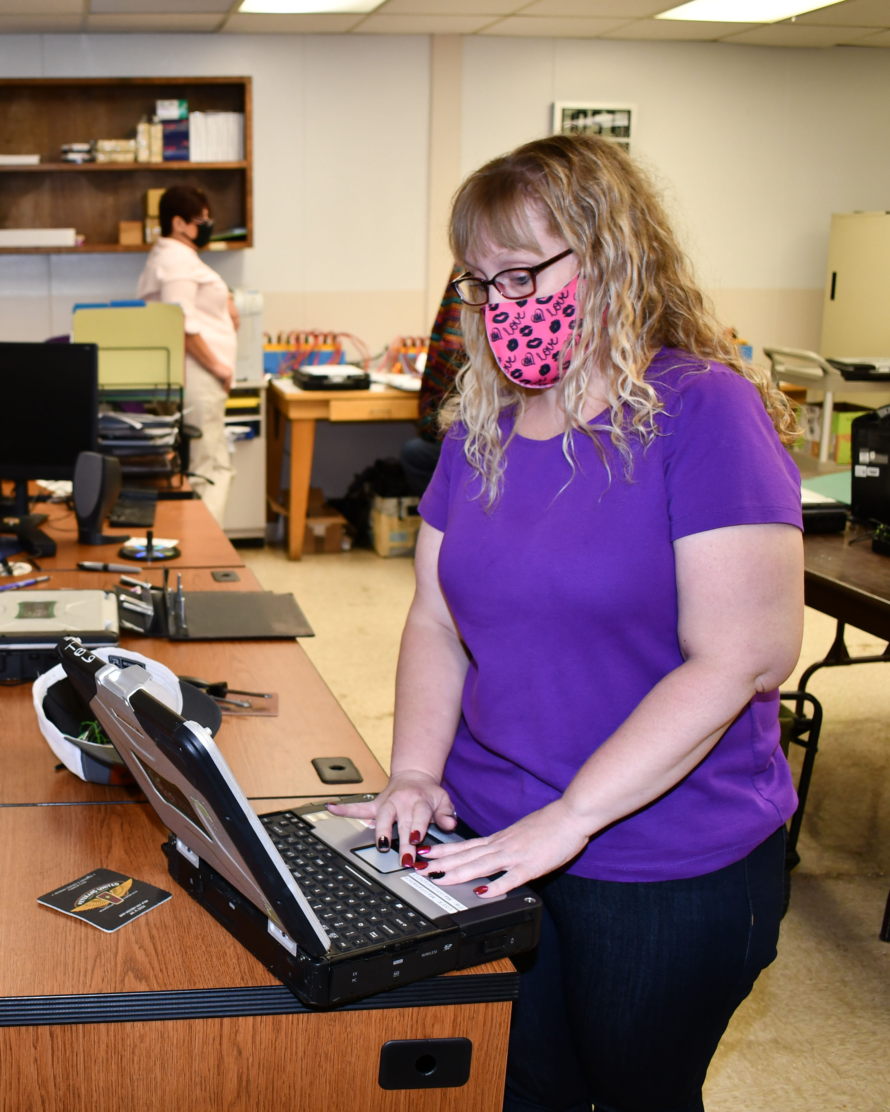 Data management specialist updates an electronic manual.