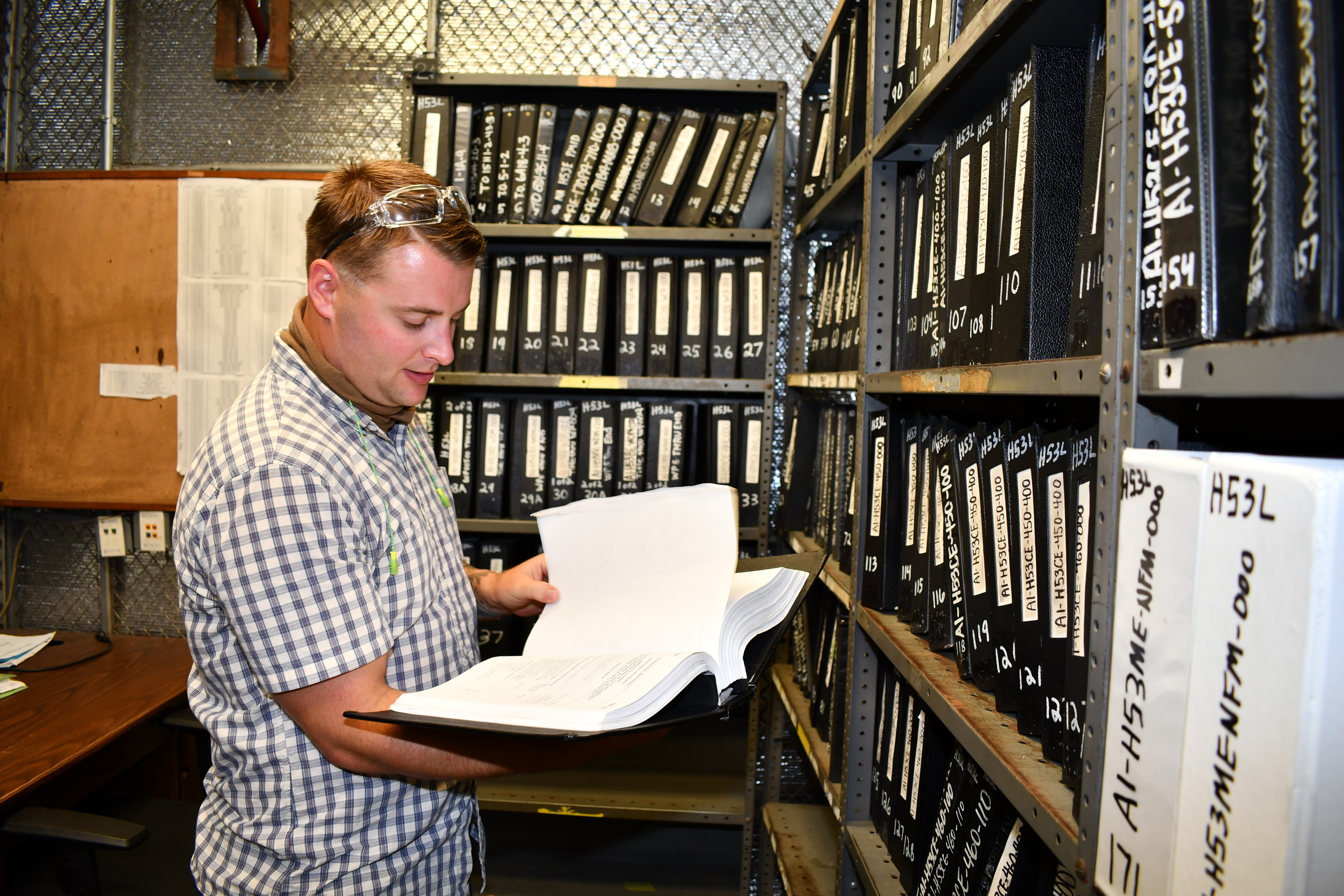 Data management technician edits technical manual.