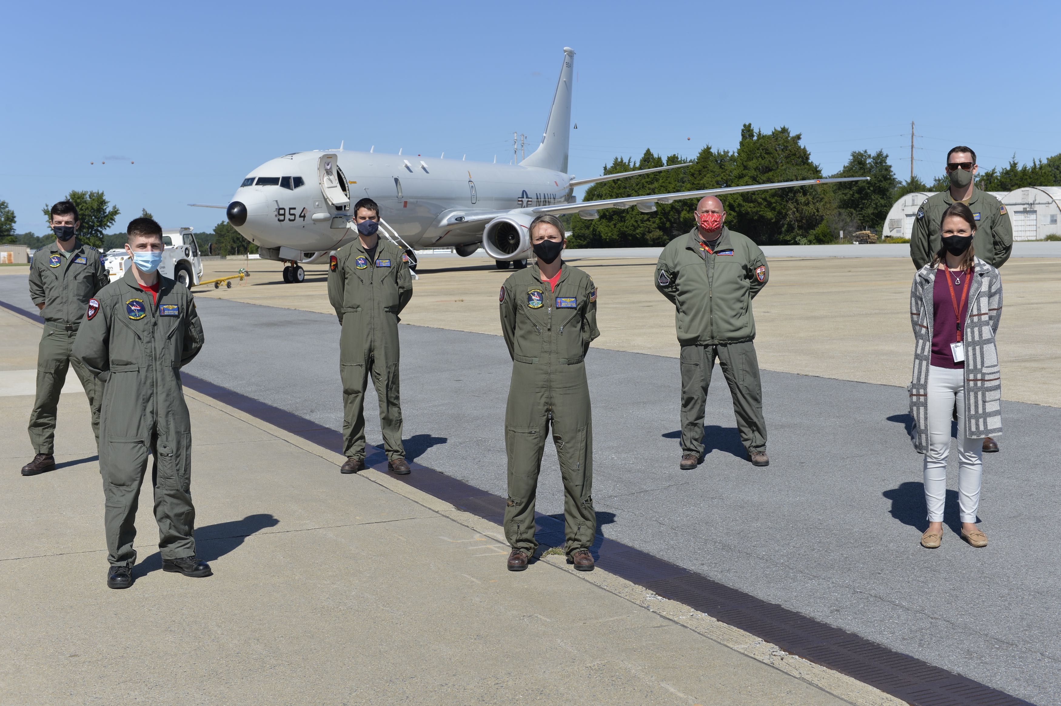 Katie Giewont, second from right, a Harpoon flight test engineer, joins the crew of "Score 42," a P-8A Poseidon assigned to Air Test and Evaluation Squadron (VX) 20, whom she guided during a recent search-and-rescue mission near Wallops Island, Va. The P-8A crew included (from left to right) Royal Australian Air Force SQNLDR Joseph Mack, AWO2 Andrew Harlan, Lt. Cmdr. Nathan Durham, Lt. Cmdr. Megan Stateler, Mr. Bryan Smith, and Lt. Christopher Sheehan. Not shown: Lt. Kevin Wunderly of Air Test and Evaluatio