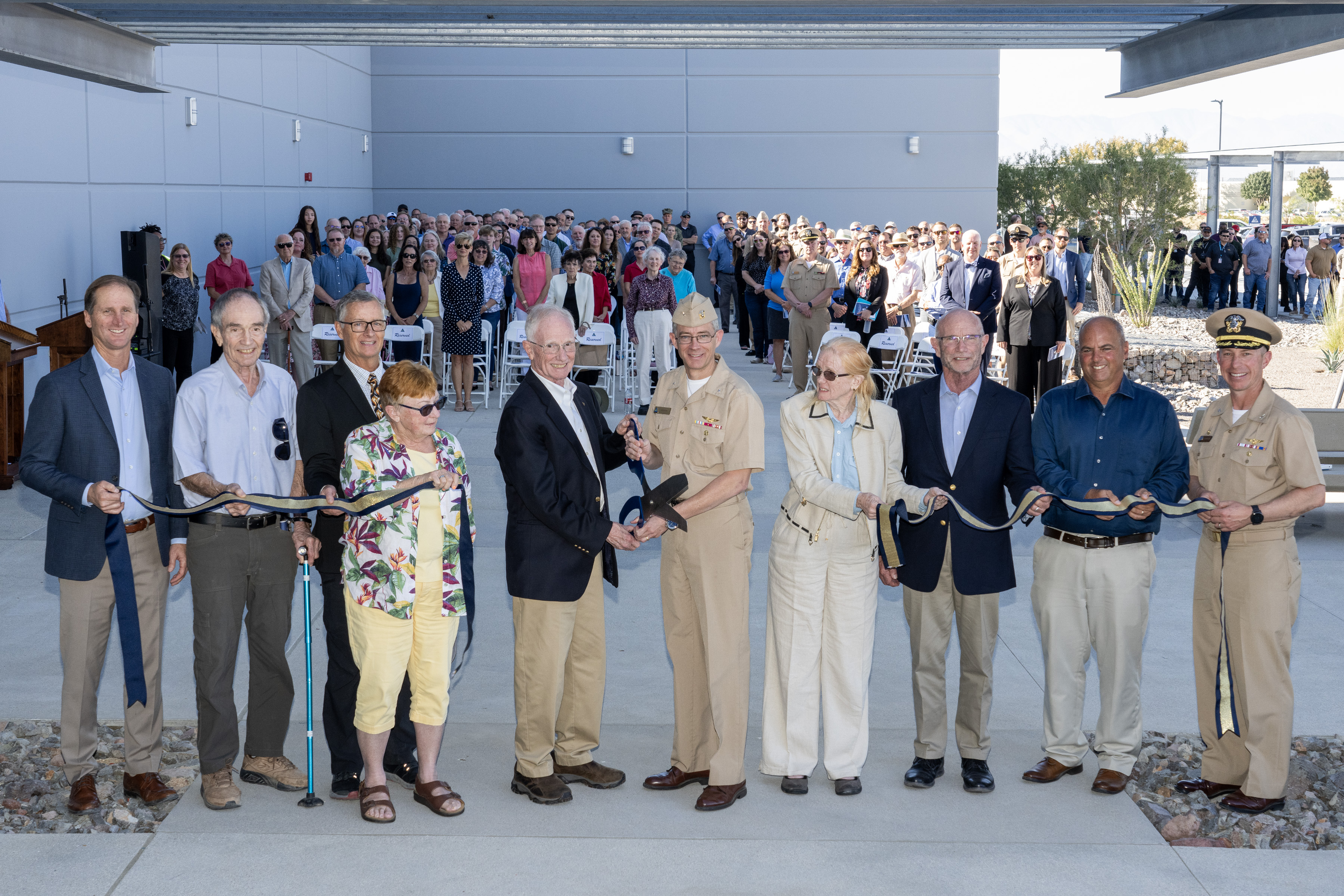 Naval Air Warfare Center Weapons Division Commander Rear Adm. Keith Hash, center right, and Alexander Rogers, Dr. Peggy Rogers’ son, center left, pose after cutting the ribbon on NAWCWD’s newest laboratory, the Dr. Marguerite “Peggy” Rogers Lab in China Lake, California, on Oct. 24. 