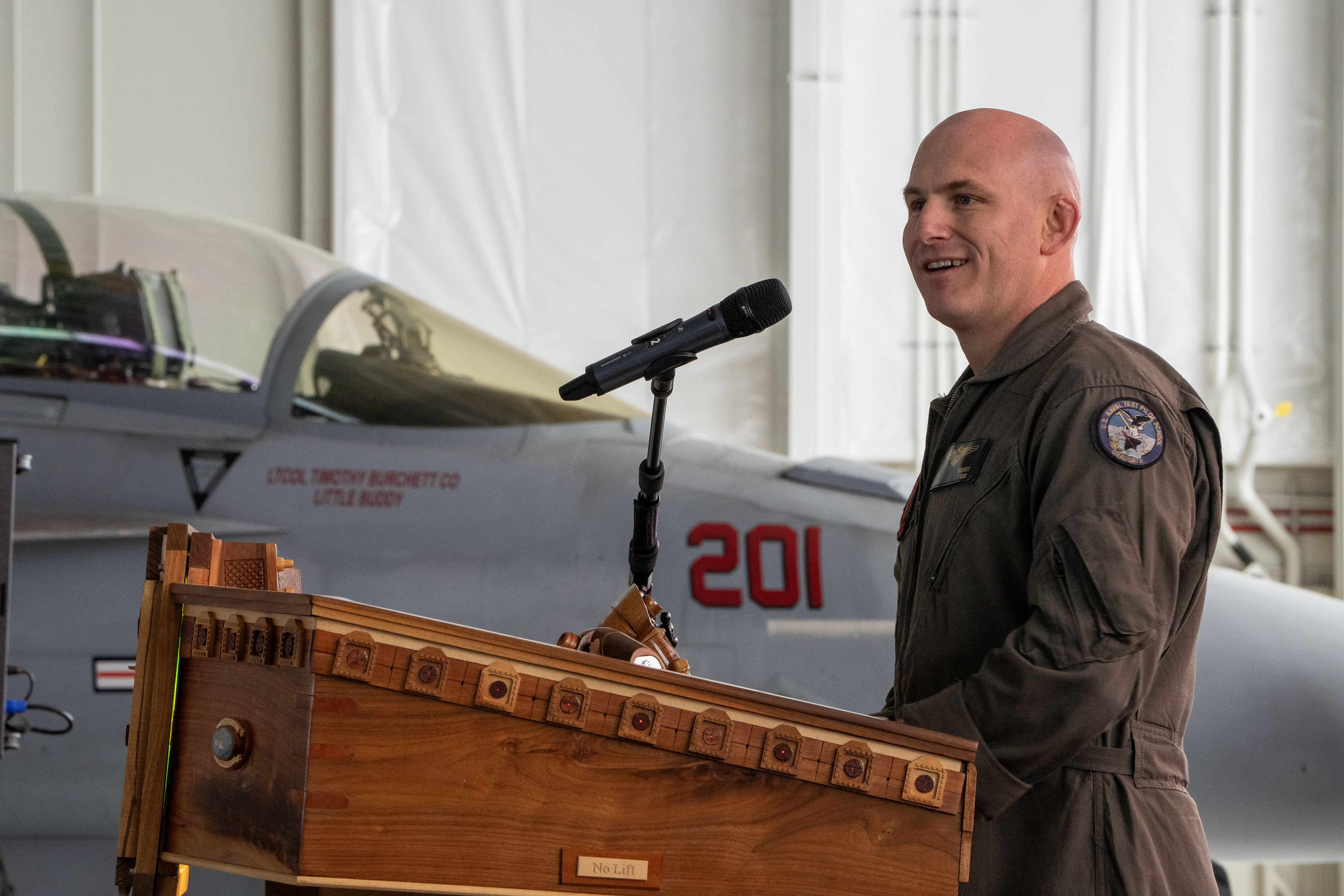 Lt. Col. Timothy “Little Buddy” Burchett, U.S. Marine Corps, delivers remarks after assuming command of VX-31 during a change of command ceremony at Naval Air Weapons Station China Lake on March 6, 2025. Burchett previously served as the squadron’s chief test pilot. (U.S. Navy photo by Ryan Smith) 