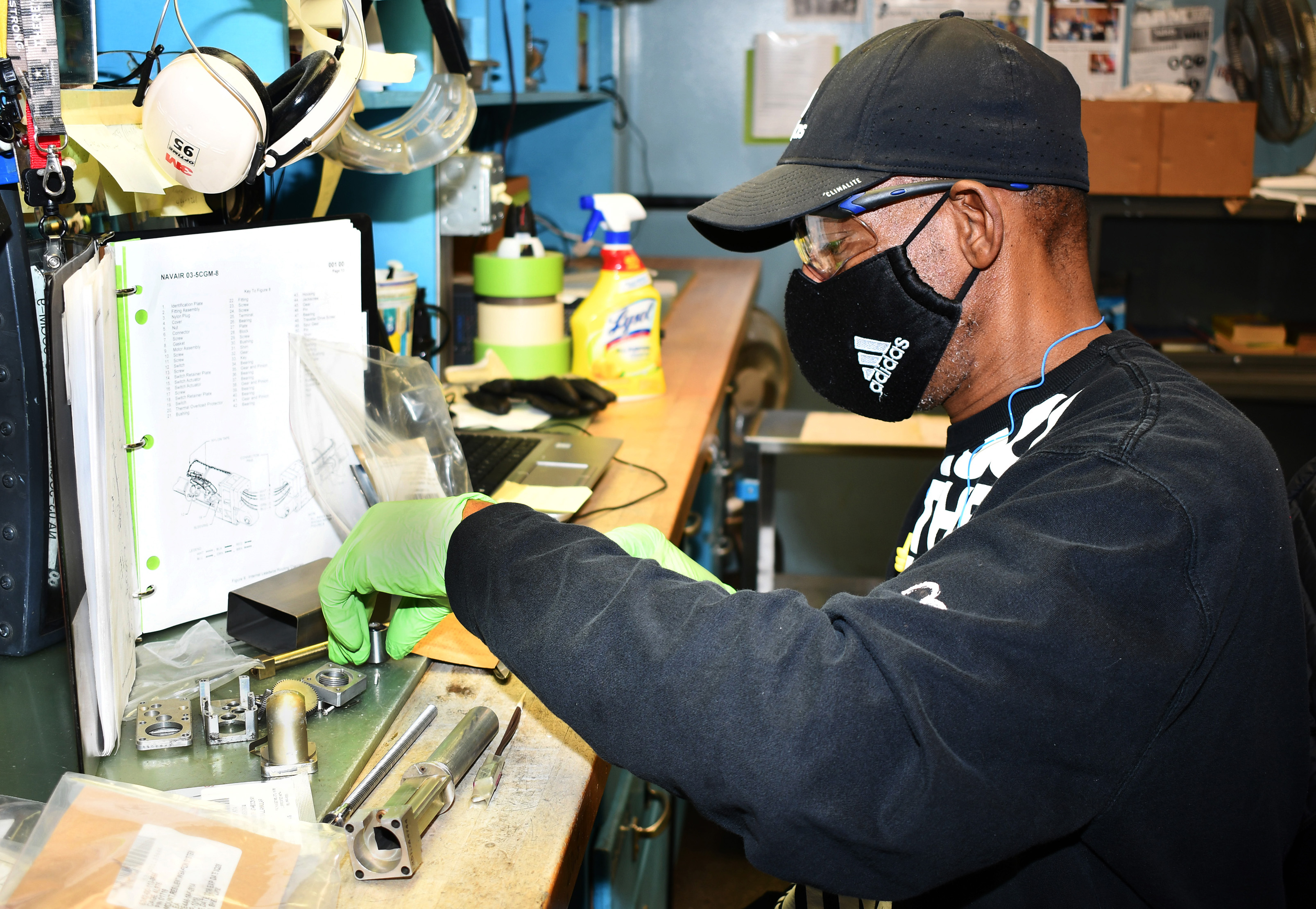 Man sorts parts on workbench