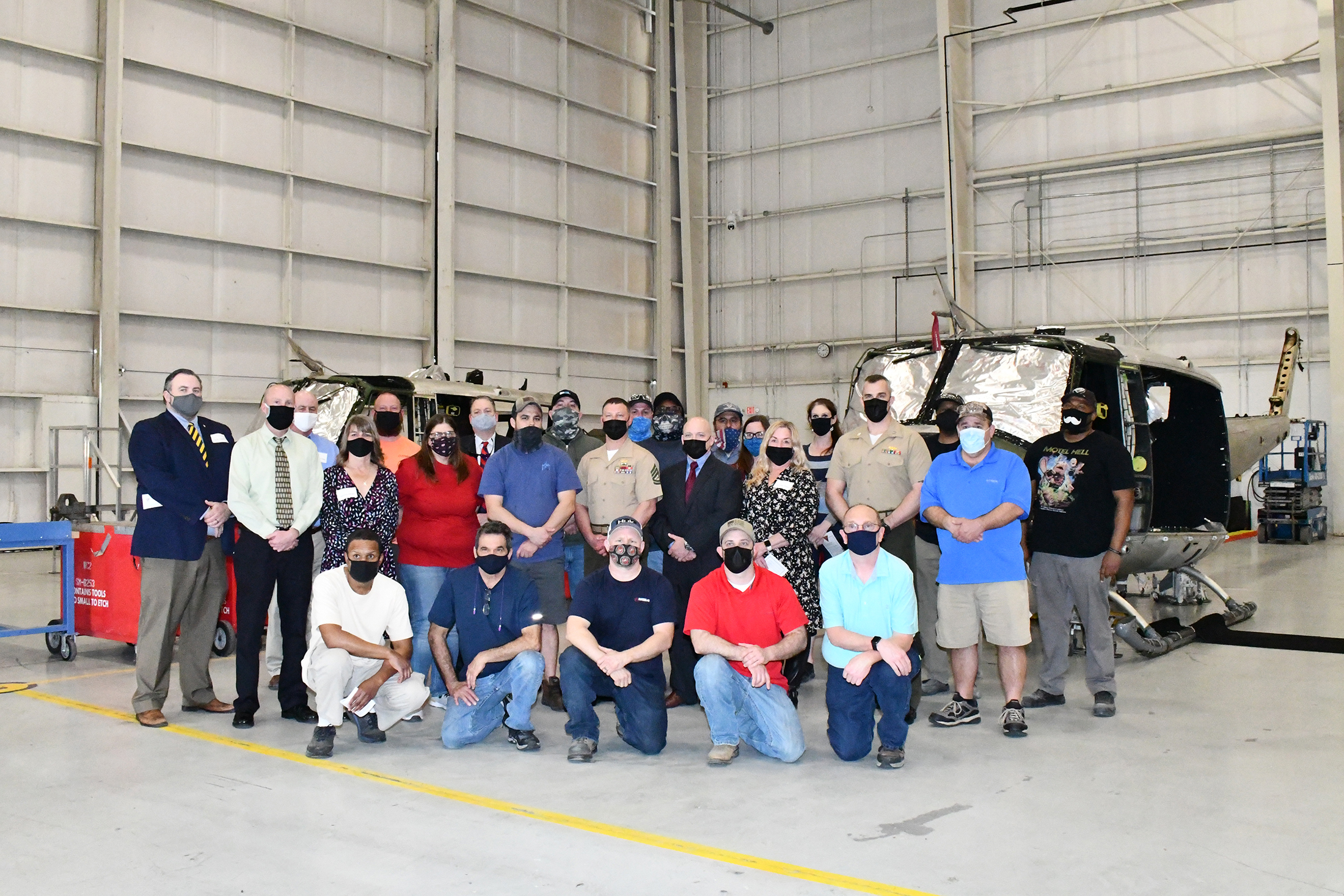 Group shot in front of H-1 helicopter airframe