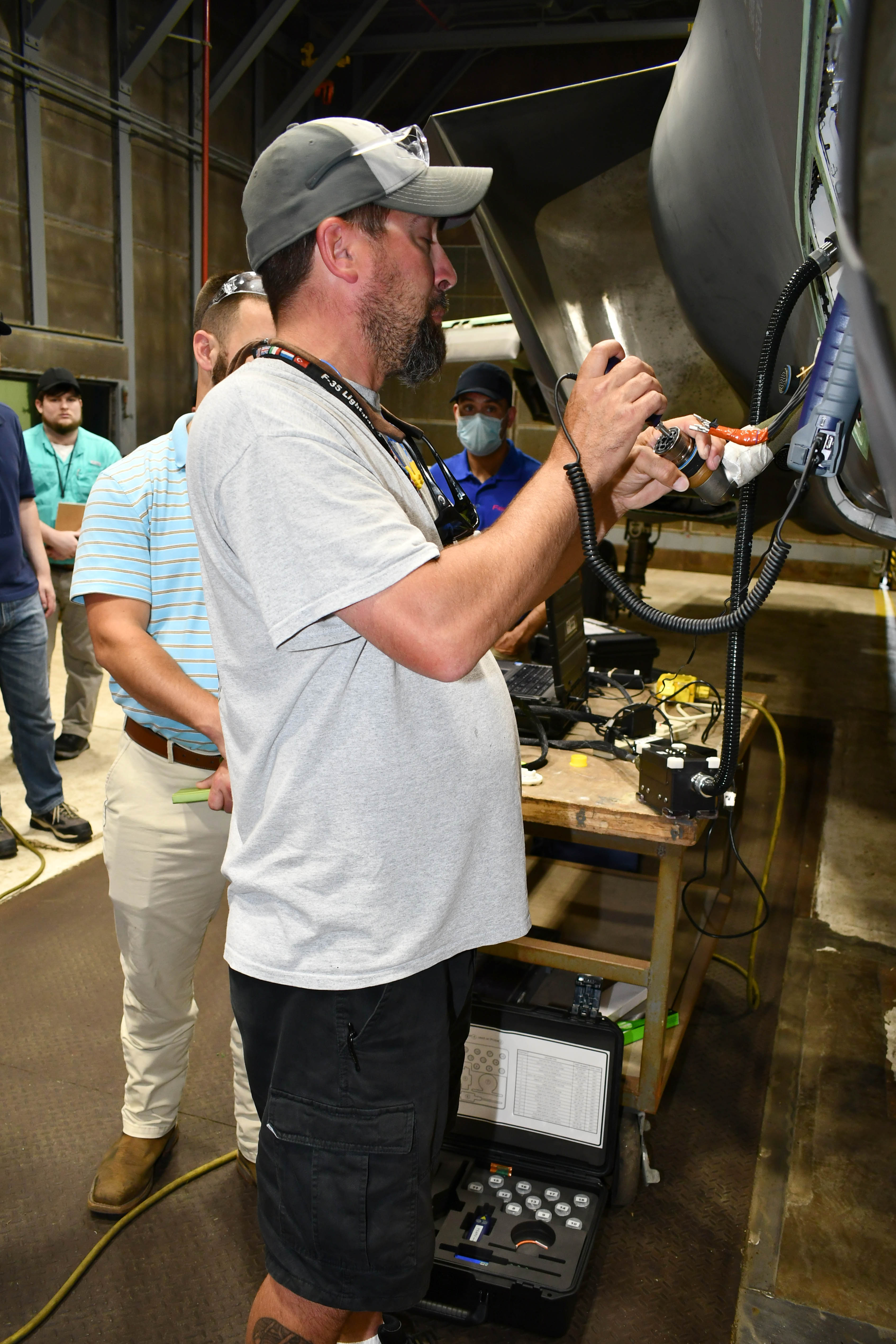 Man manually cleans fiber optic cables