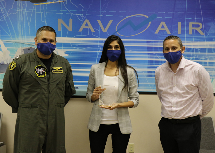 Manik Yeremyan, center, holds her Test Engineer of the Year Award, presented to her by Cmdr. Jason Saglimbene, VX-30 commanding officer, and Dan Toland, Weapons and Warfare Systems Test Department head, in a ceremony Oct. 7 in Point Mugu. (U.S. Navy photo by Kimberly Brown)