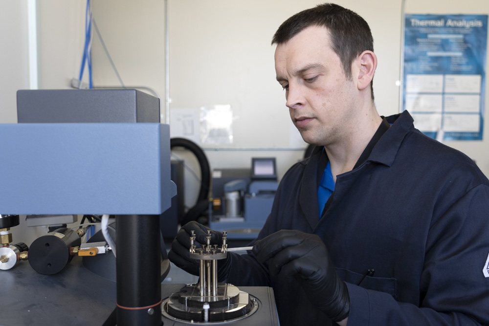 Michael Garrison, NAWCWD research chemist, loads a polymer sample for dynamic mechanical analysis. The technique allows researchers to measure the mechanical properties of polymers at different temperatures. (U.S. Navy photo by Scott Clarke)