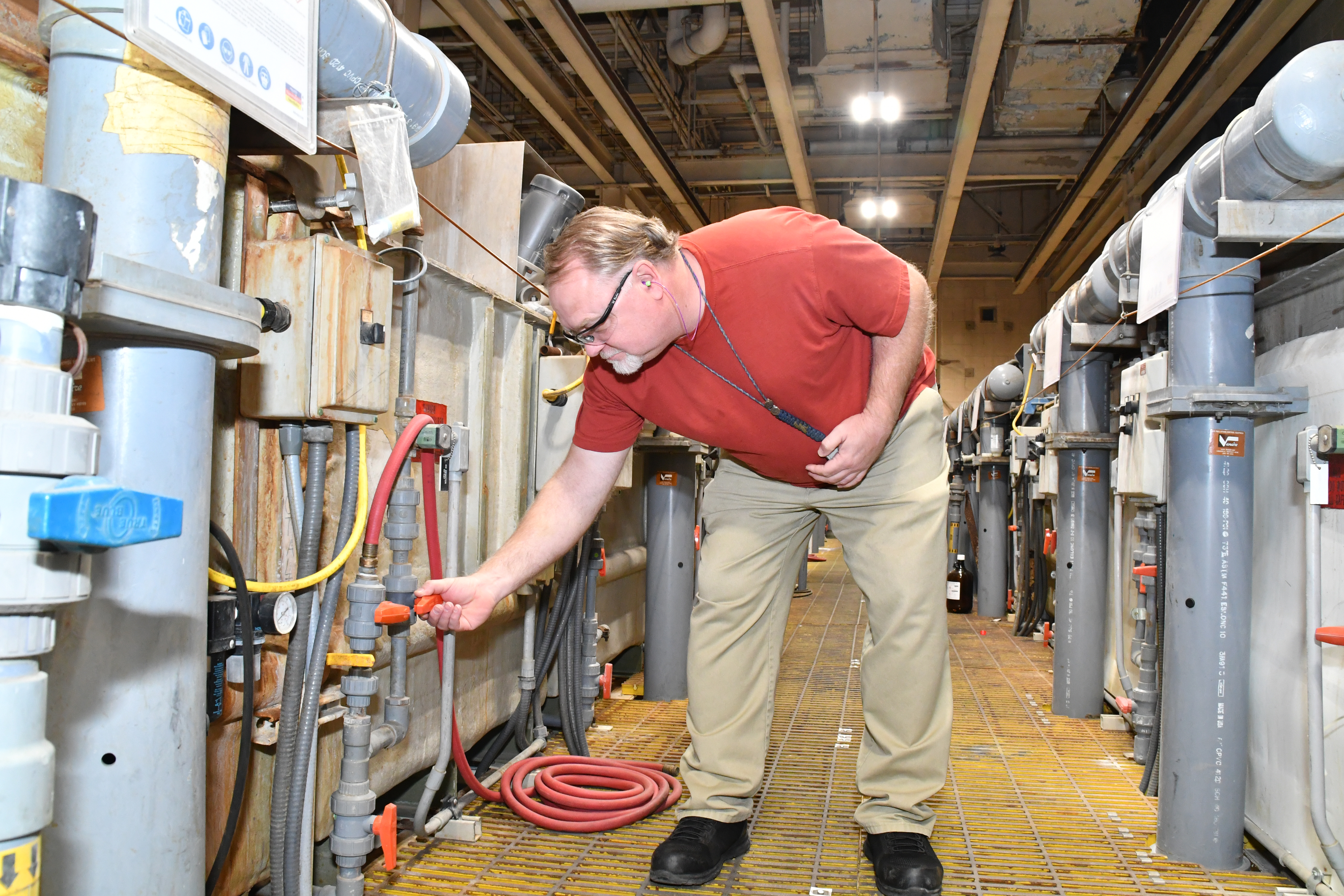 James Small, a blade and vane repairer at Fleet Readiness Center East (FRCE), checks water valves at building 4225. According to FRCE environmental officials, efforts to cut industrial wastewater generation have resulted in reductions of more than sixty thousand gallons per day in Building 4225 alone. Last year FRCE reduced its total industrial wastewater generation by 45%, exceeding its goal of achieving a 30% reduction in 2021. 