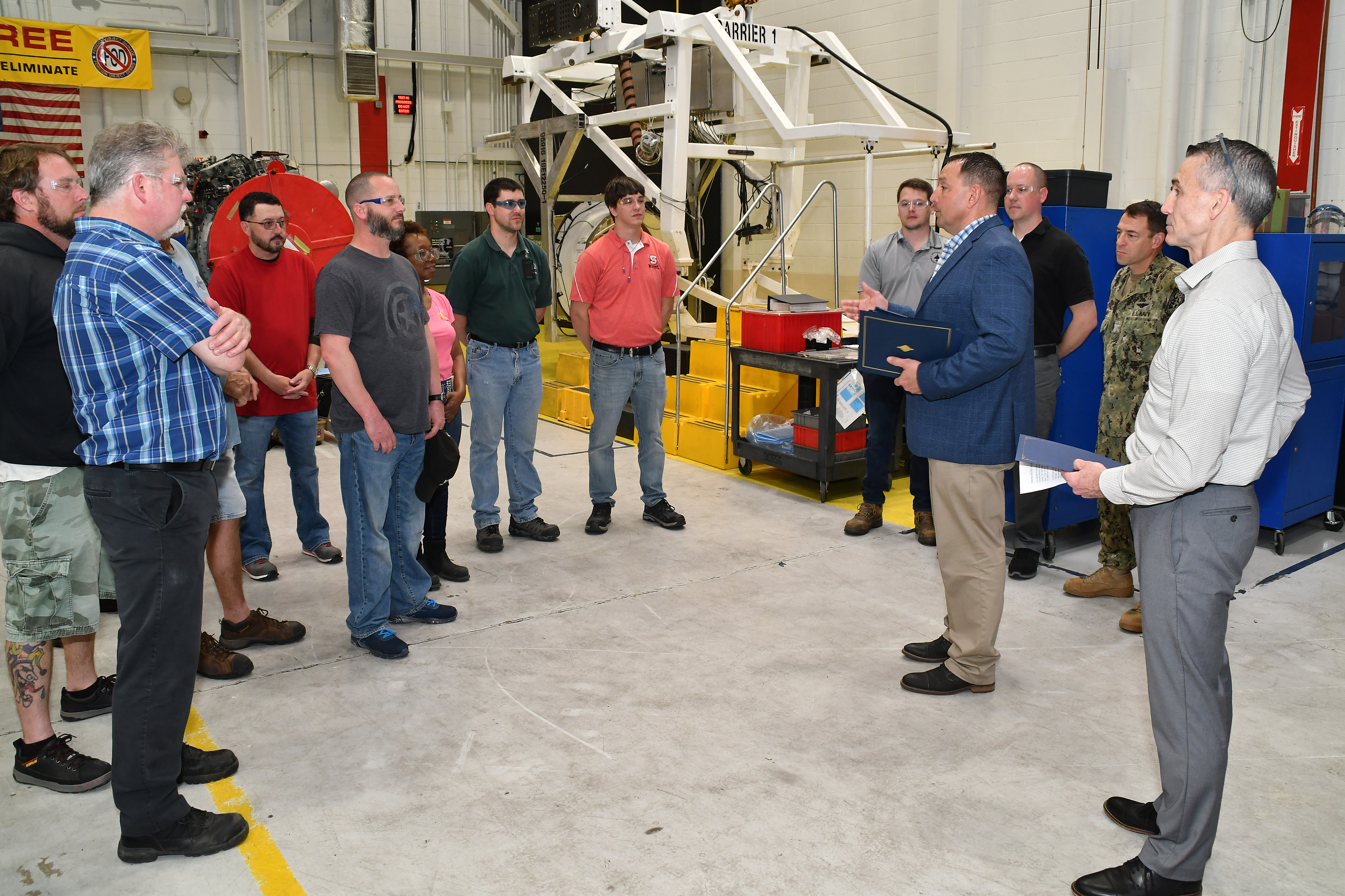 Col. Mark R. Amspacher, second from right, AV-8B Weapon Systems Program Office (PMA-257) manager, delivers remarks to FRCE staff prior to presenting letters of appreciation Mar. 31. PMA-257 recognized FRCE for its outstanding support of the AV-8B Propulsion Integrated Product Team and the AV-8B Harrier fleet.