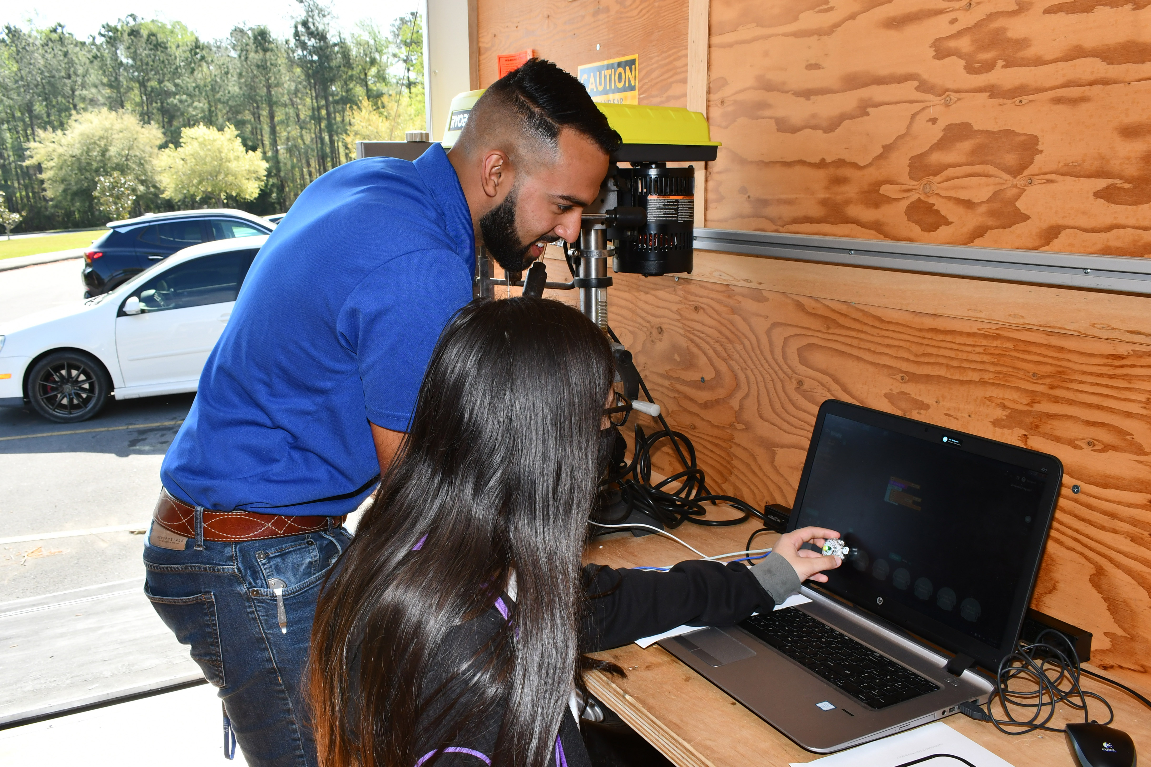Engineer helps student program computer