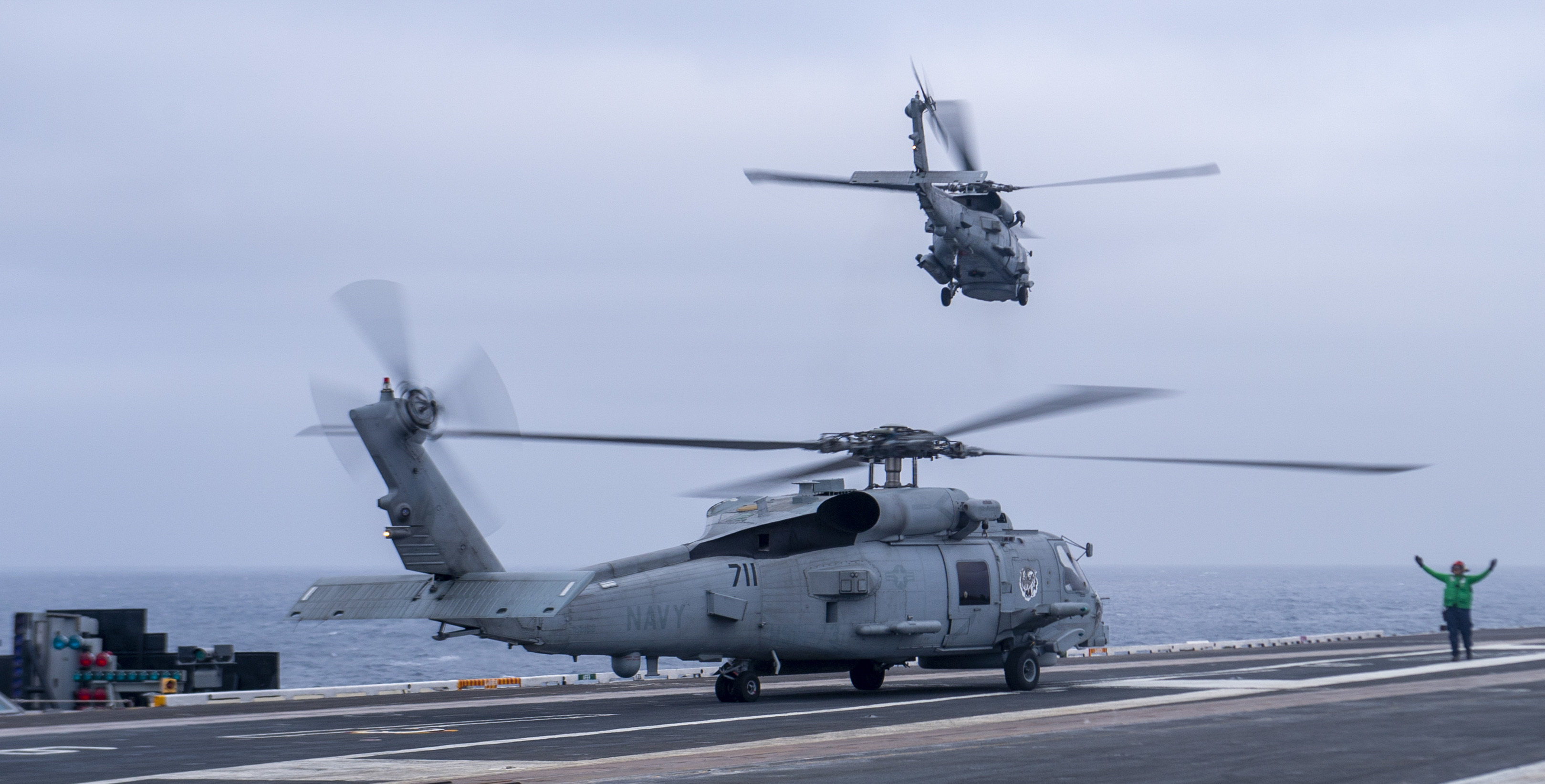 MH-60R on runway and taking off from USS Nimitz May 2022