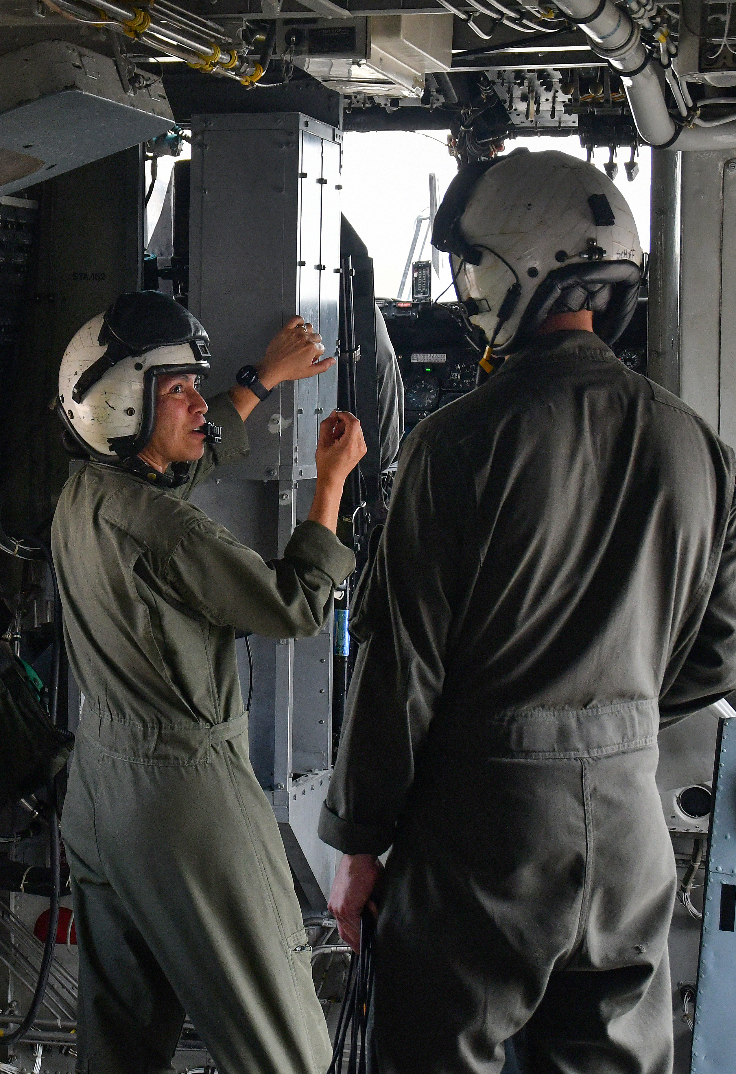 Maj. Brittany Fayos, left, Military Aircraft Production Deputy Director and CH/MH-53 pilot at Fleet Readiness Center East (FRCE), talks with a crew chief prior to conducting a functional check flight inspection of a CH-53 Sea Stallion helicopter. 