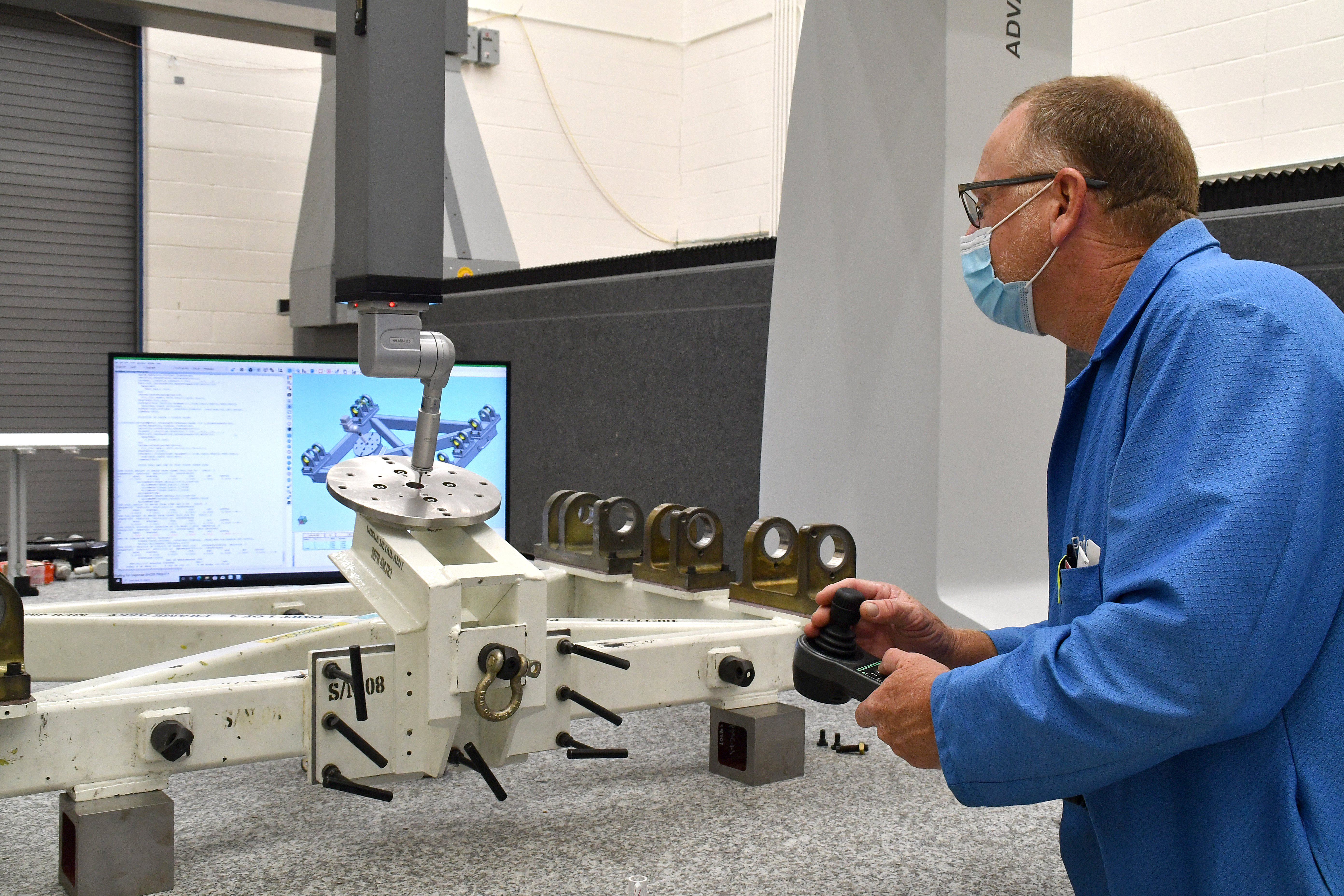 Ben Pate, operations manager at Fleet Readiness Center East’s (FRCE) Precision Measurement Center, operates a coordinate measuring machine (CMM). A CMM is a device that measures the geometry of physical objects by sensing points on the surface of the object with a probe. 