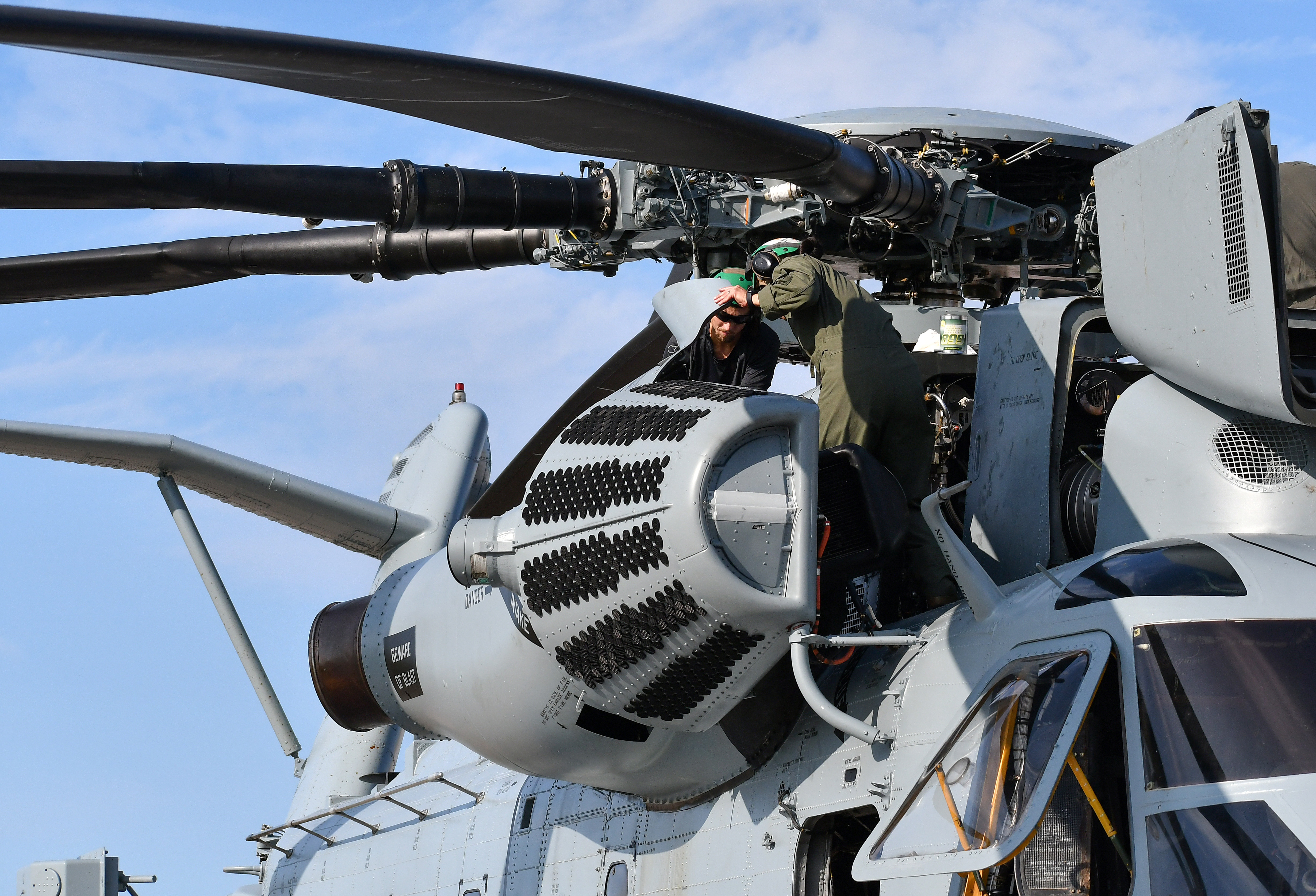 Fleet Readiness Center East (FRCE) Rotary Wing Division deputy and CH-53 pilot Maj. Brittany Fayos, right, and Alex Talley, an aircraft mechanic at FRCE, conduct a functional check flight inspection prior to the delivery of a recently overhauled CH-53 helicopter to the fleet.