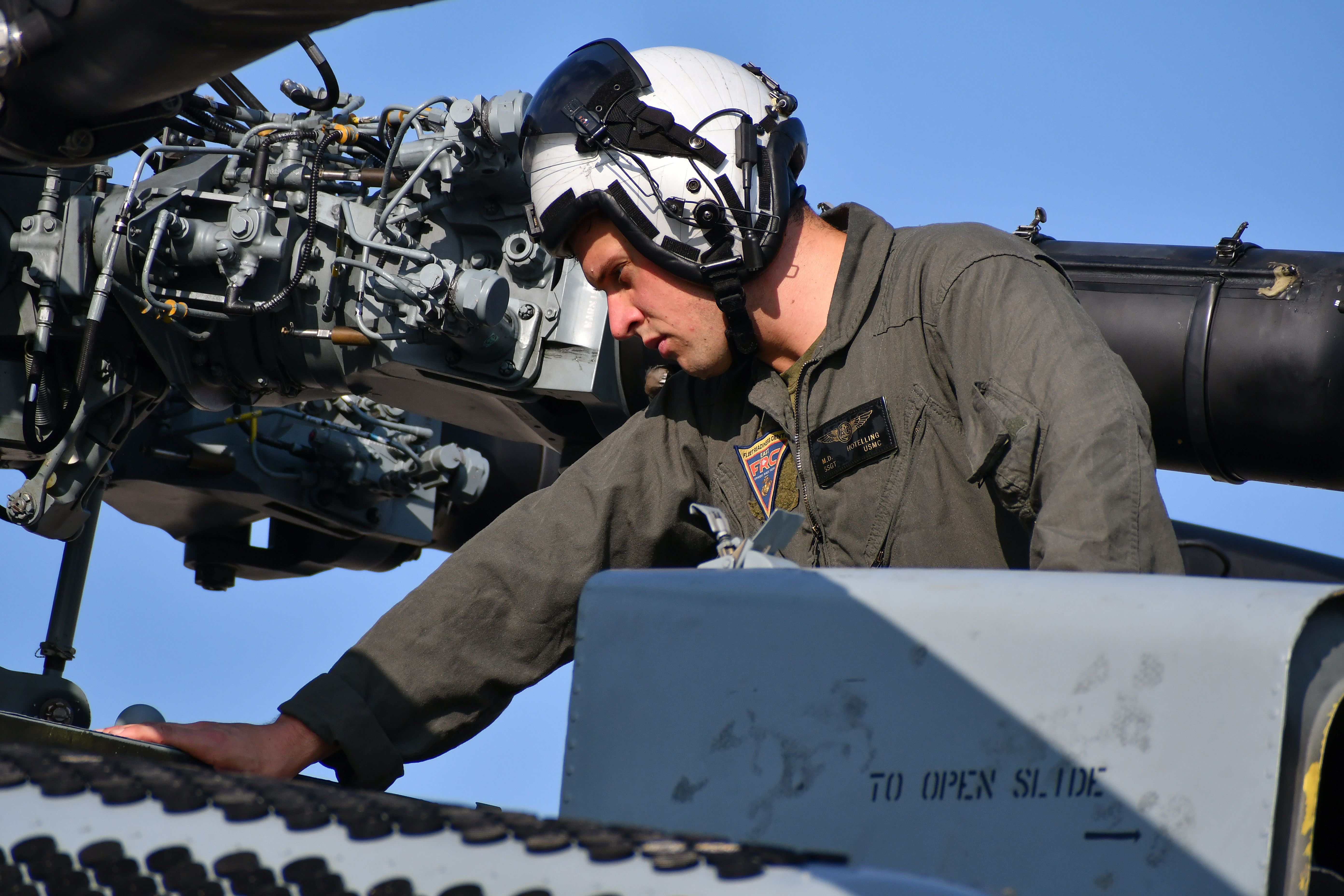 Staff Sgt. Matthew Hotelling, H-53 Military Branch deputy and CH-53 crew chief at Fleet Readiness Center East (FRCE), conducts a functional check flight inspection prior to the delivery of a recently overhauled CH-53 helicopter to the fleet.
