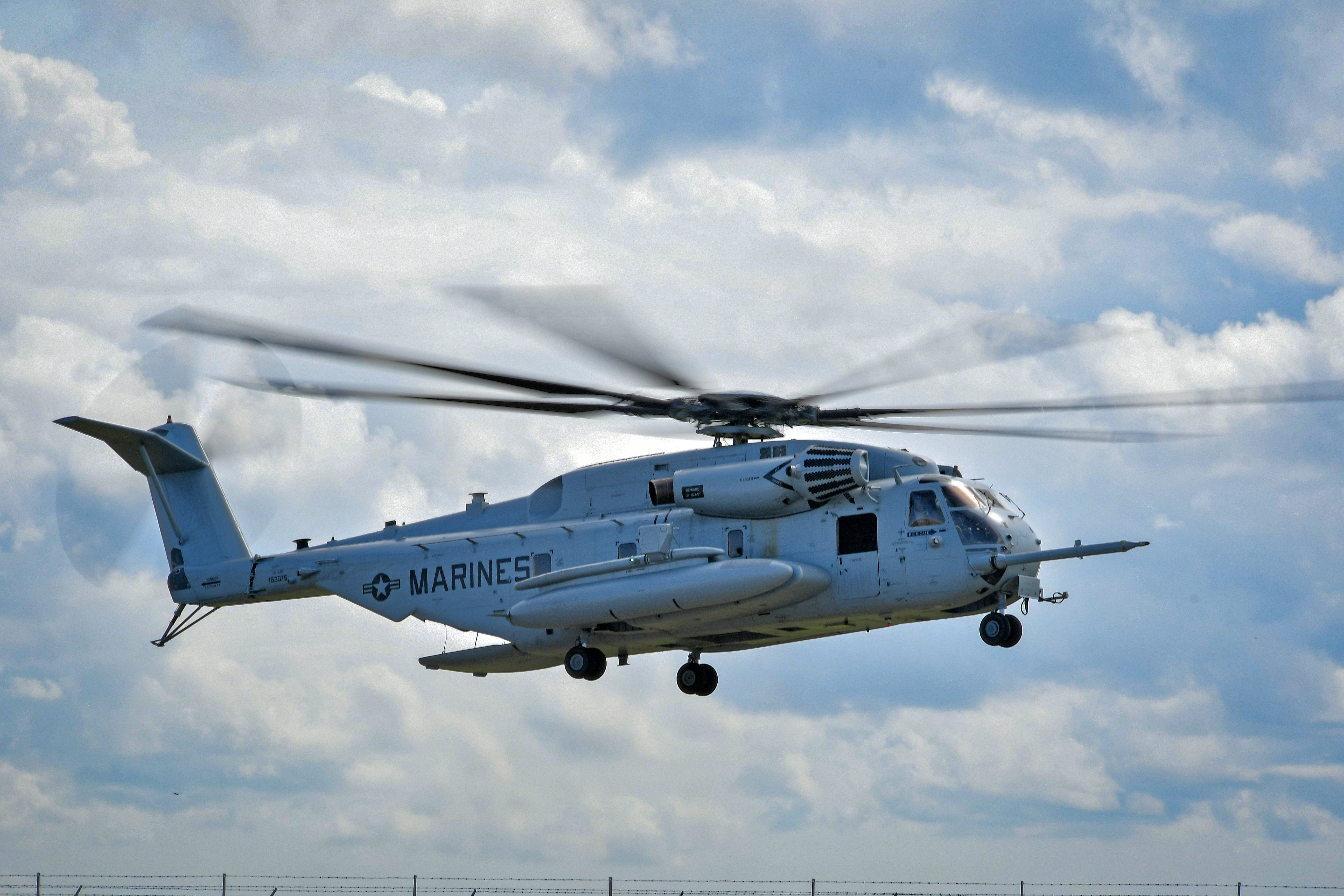 Maj. Brittany Fayos, Military Aircraft Production Deputy Director and CH/MH-53 pilot at Fleet Readiness Center East (FRCE), flies a recently overhauled CH-53 Sea Stallion helicopter for delivery to the Fleet. 