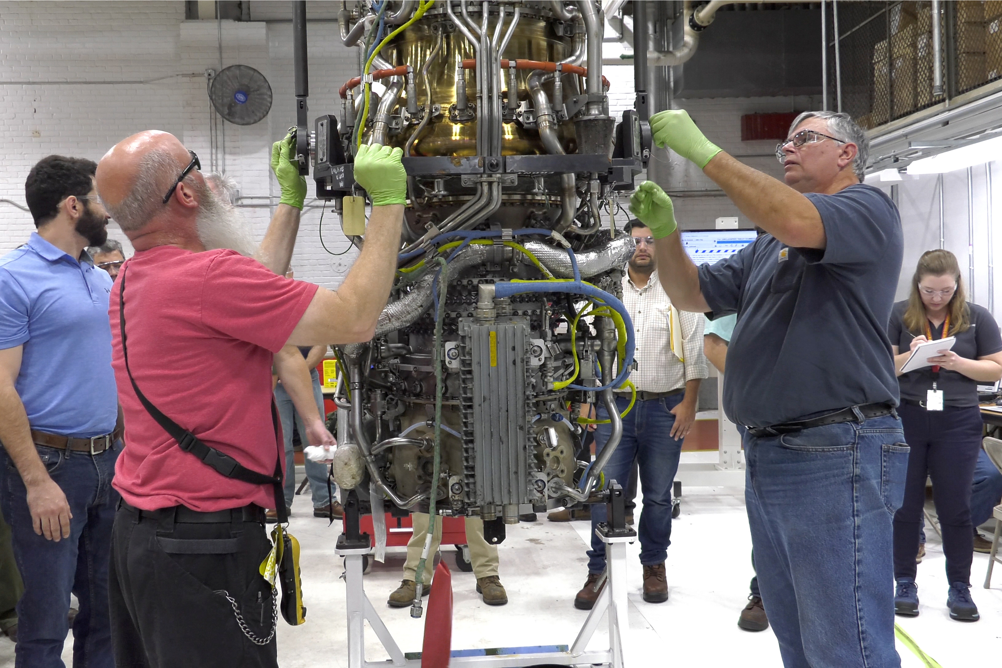 Mechanics disassemble engine