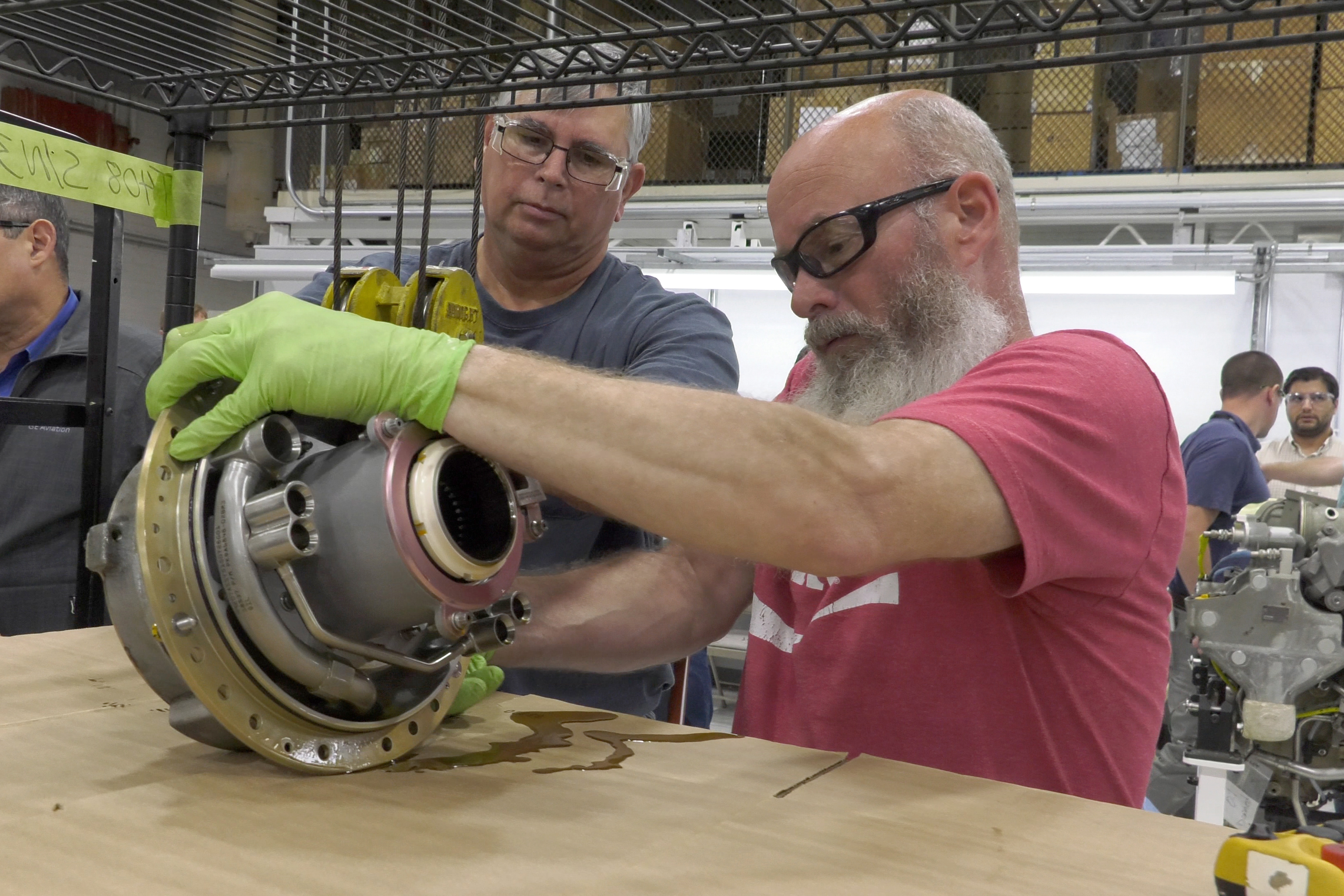 Mechanics inspect engine part