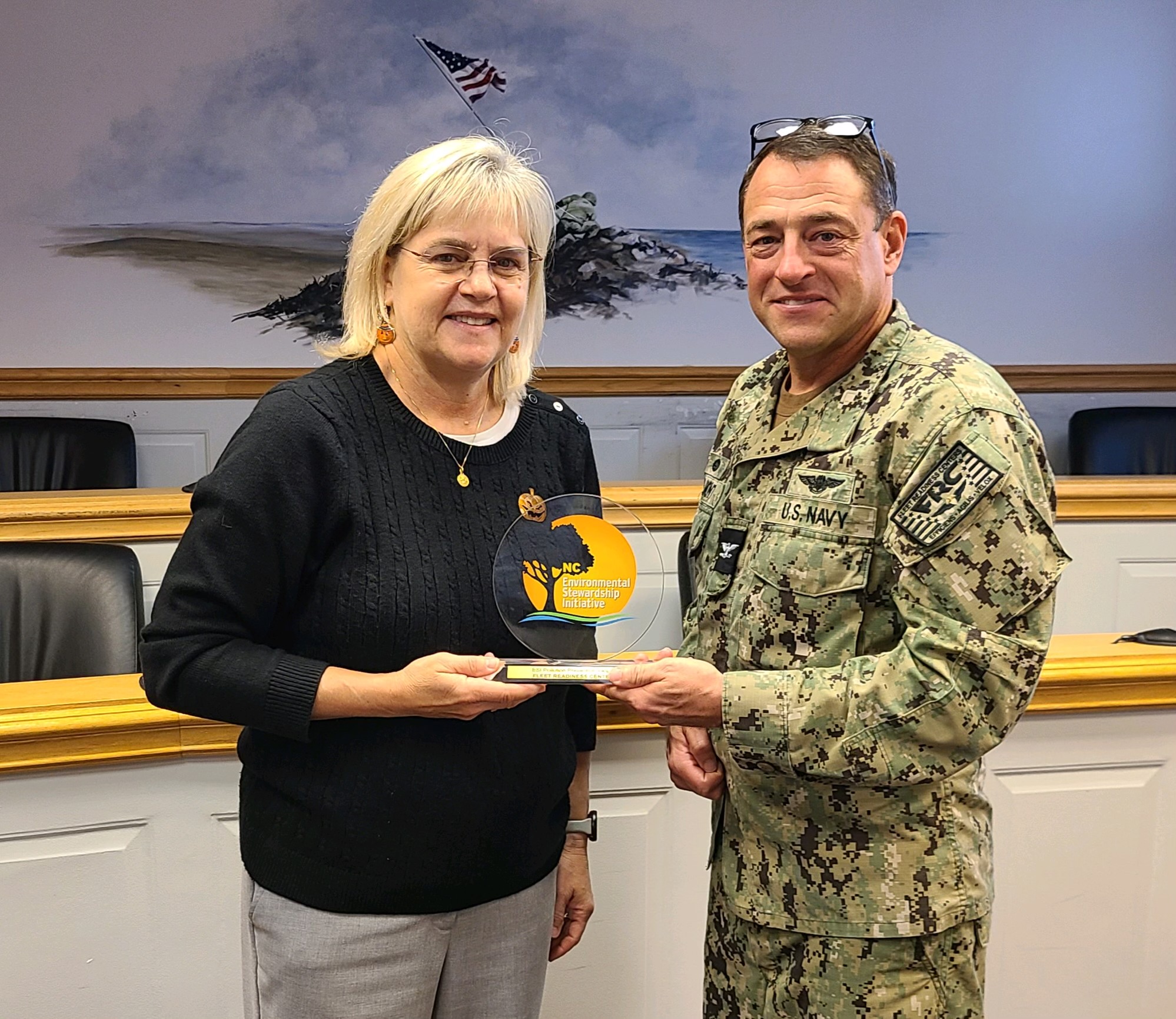 Fleet Readiness Center East (FRCE) Commanding Officer Capt. James M. Belmont (right) and FRCE Compliance and Quality Department Head Amy Morgan display the P2 Award for pollution prevention. FRCE received the award during the North Carolina Department of Environmental Quality’s Environmental Stewardship Initiative Conference, held October 24-25 in Raleigh. FRCE earned the honor in recognition of a successful industrial wastewater reduction and water conservation initiative that took place at the depot. 