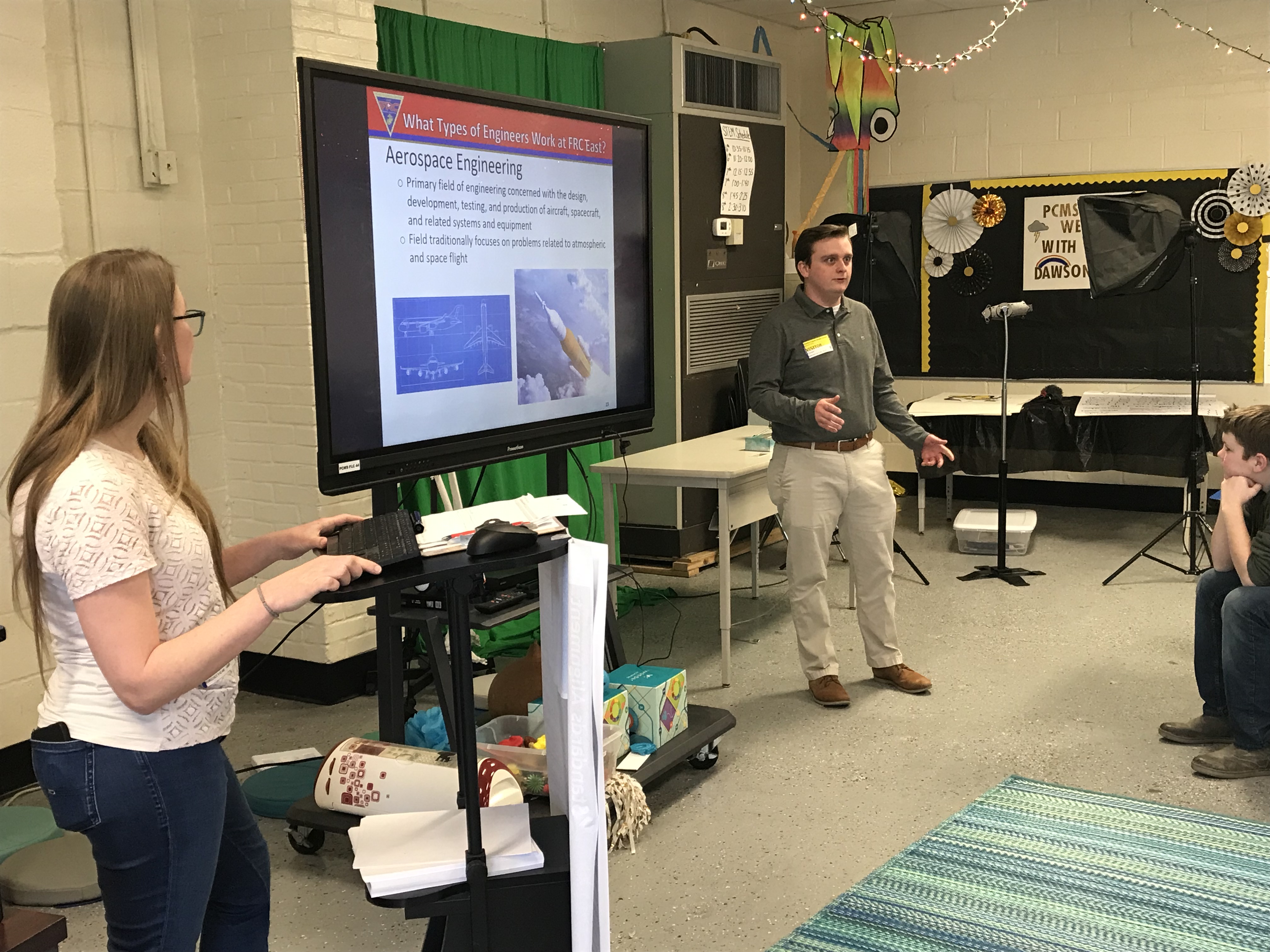 Engineers from Fleet Readiness Center East (FRCE) speak with students at Pamlico Middle School. The presentation was part of the depot’s National Engineers Week outreach efforts, which saw FRCE engineers visiting four elementary schools, 18 middle schools and four high schools in Eastern North Carolina and engaging with more than 2,700 area students. 